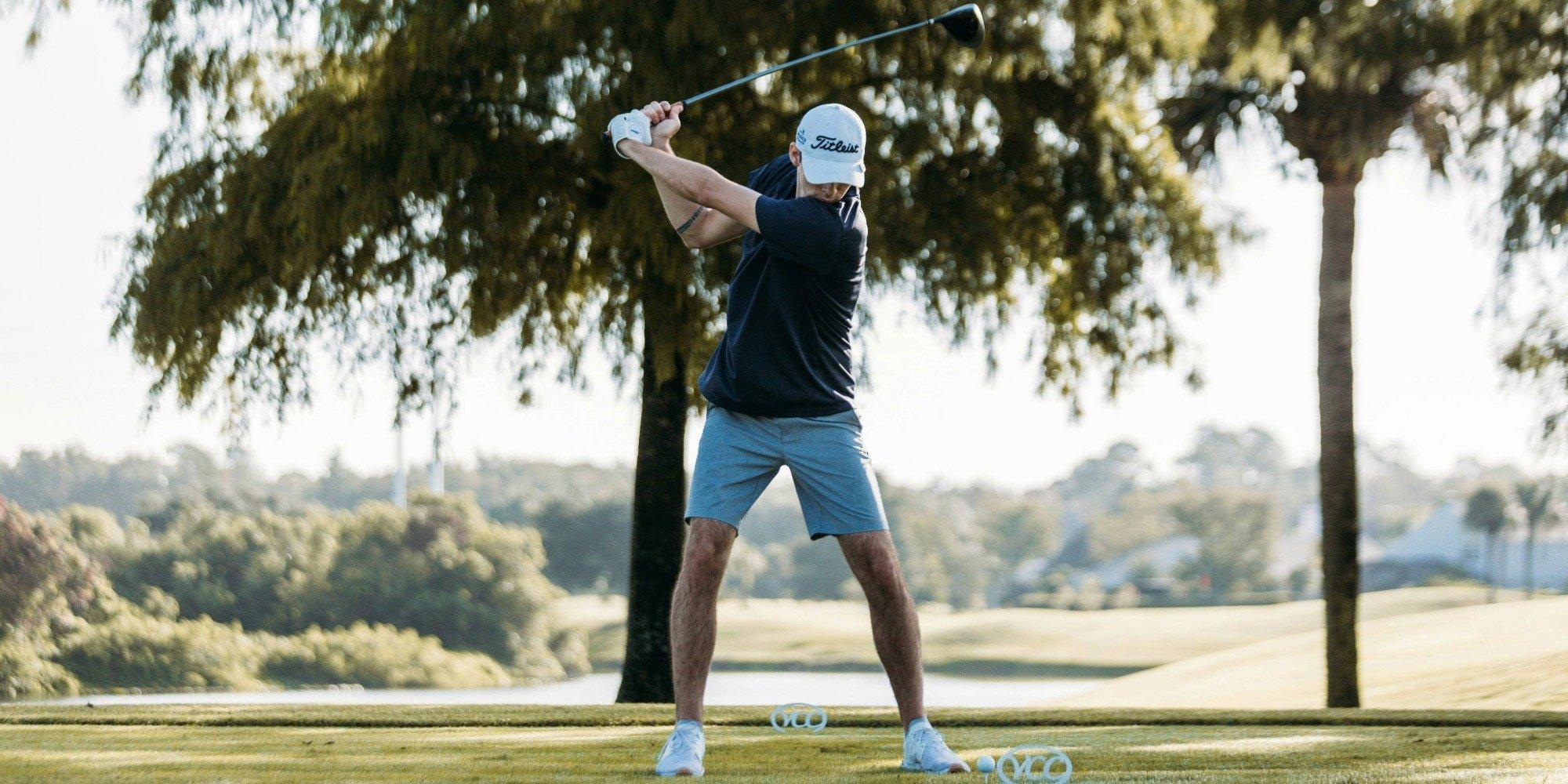 A man swinging a golf club