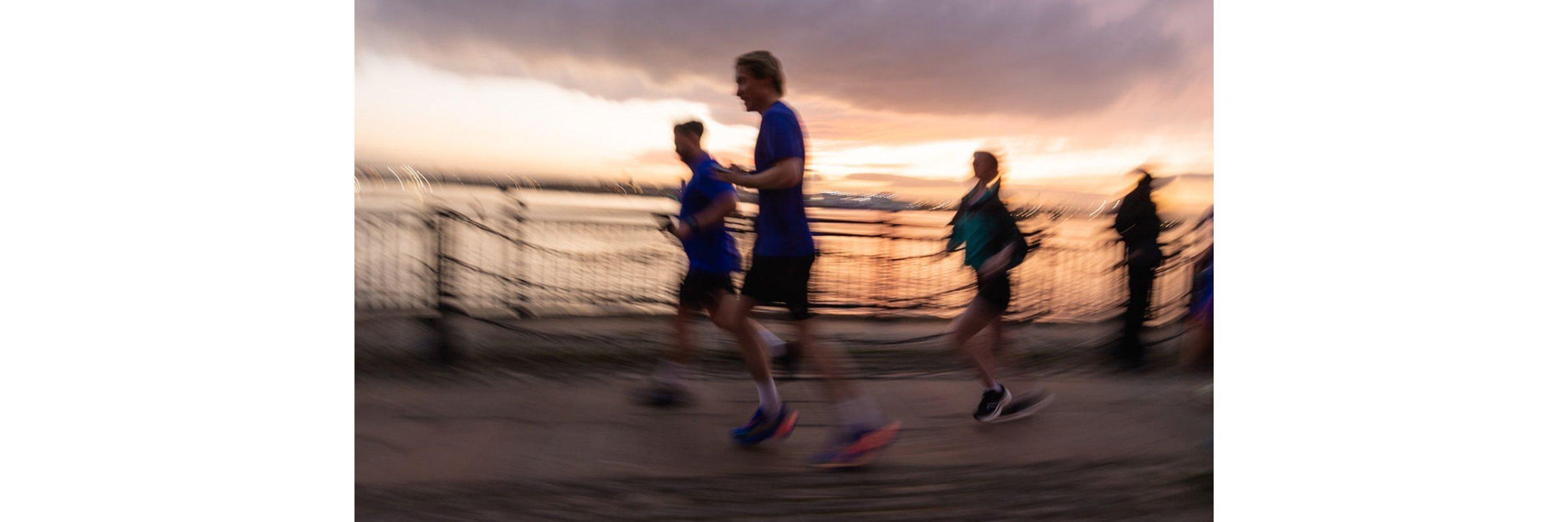 Blurred image of people running wearing running gear