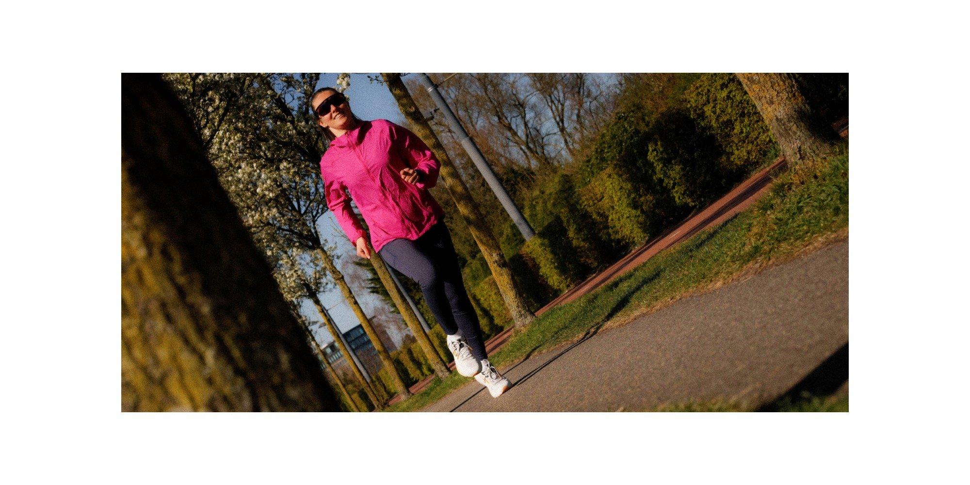 Woman wearing running gear, running in a park