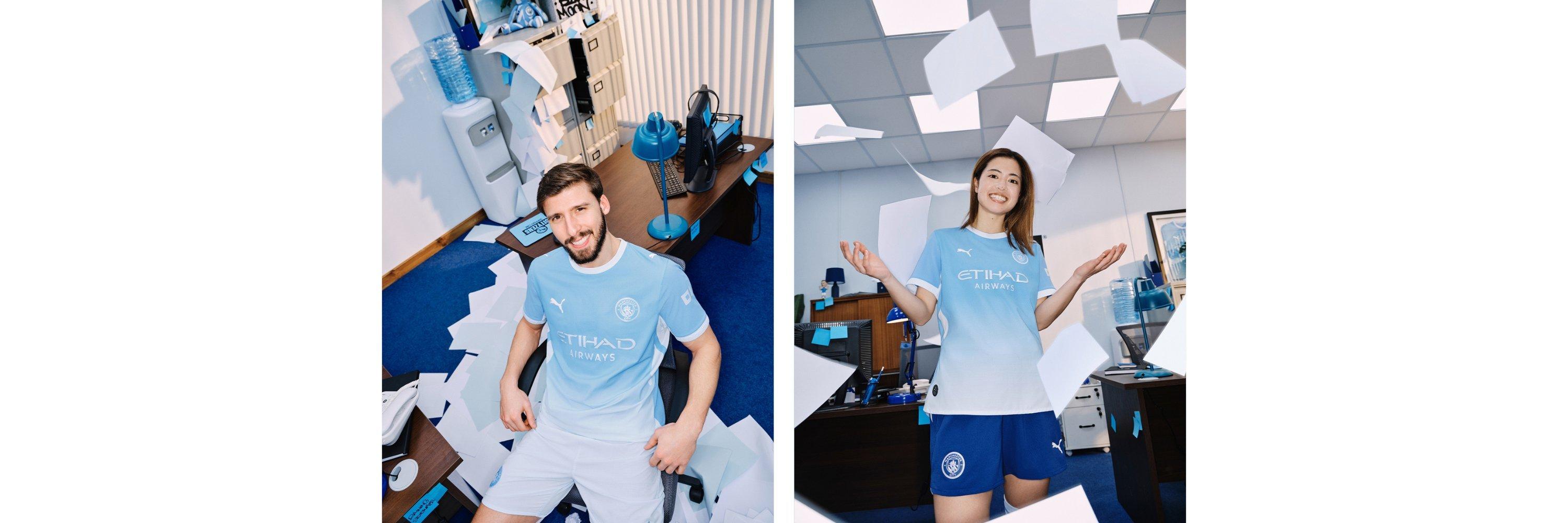 A picture of two football players wearing the new Manchester City 2026 / 2027 Premier League Kit in an office setting
