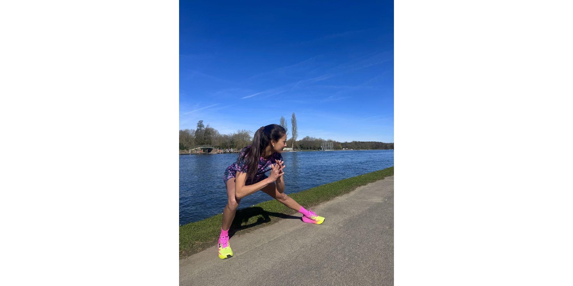 Priya doing a stretch next to a river