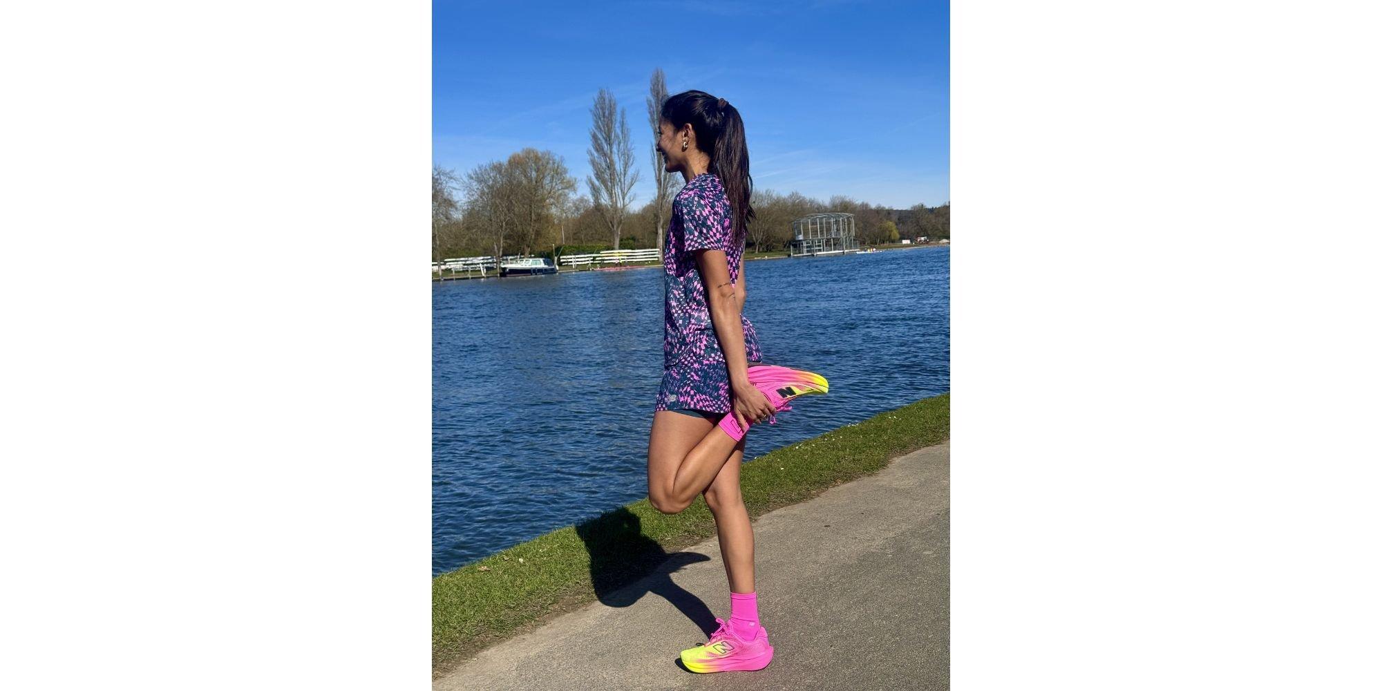 Priya stretching next to a river