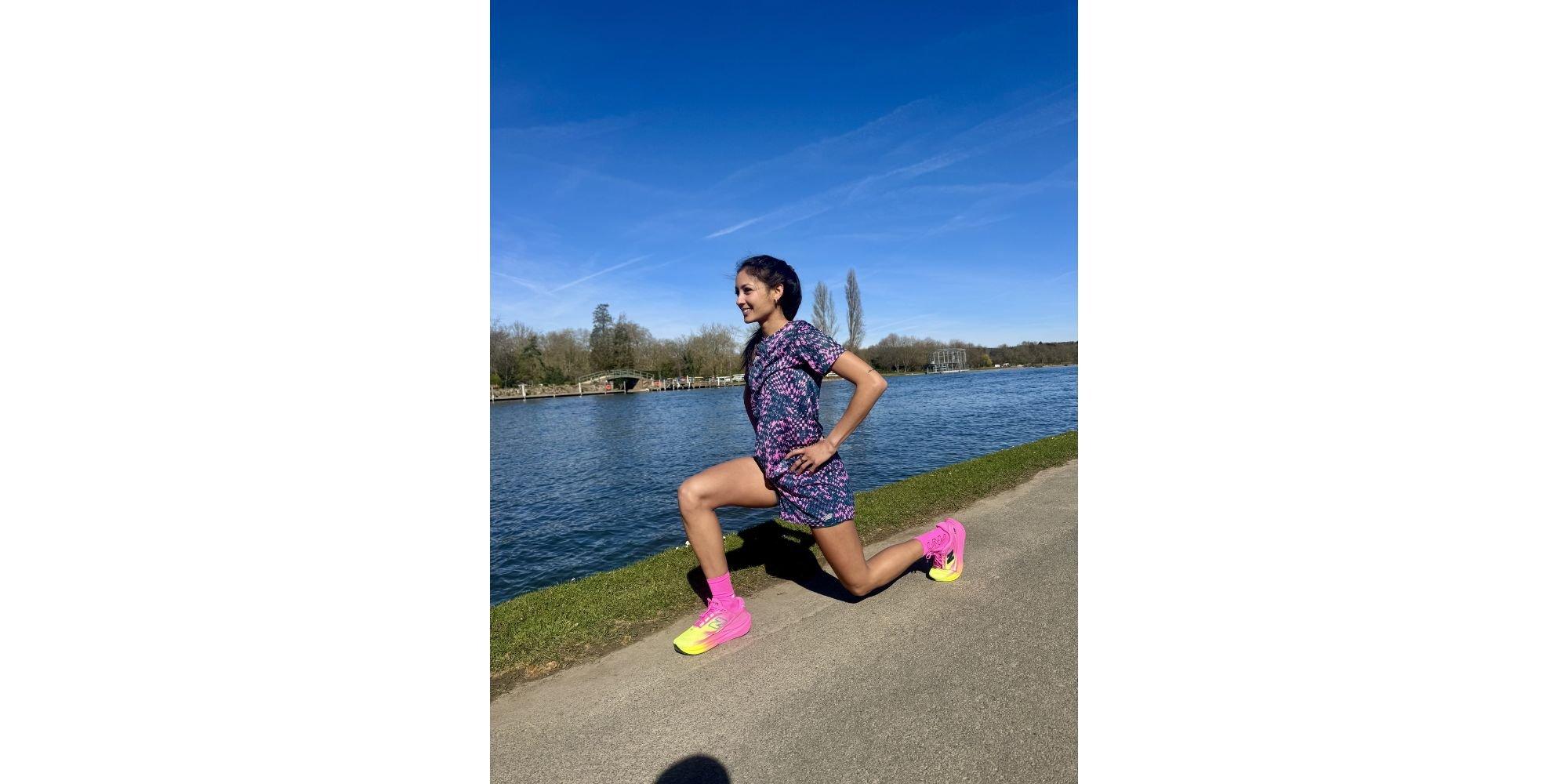 Priya doing a lunge next to a river