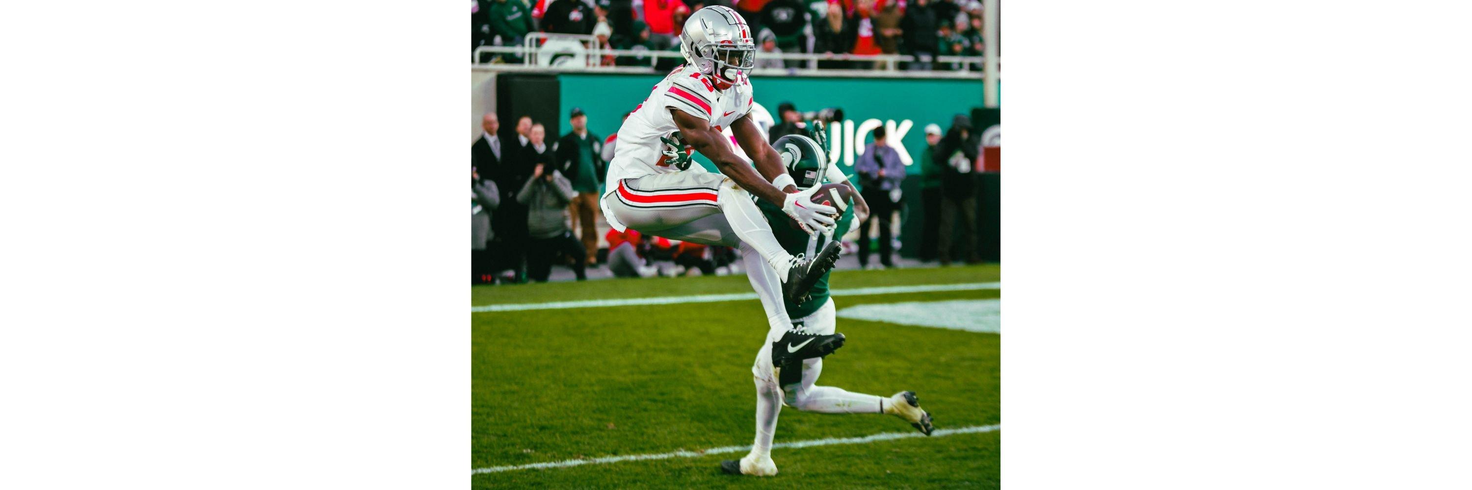 An American Football player catching the ball