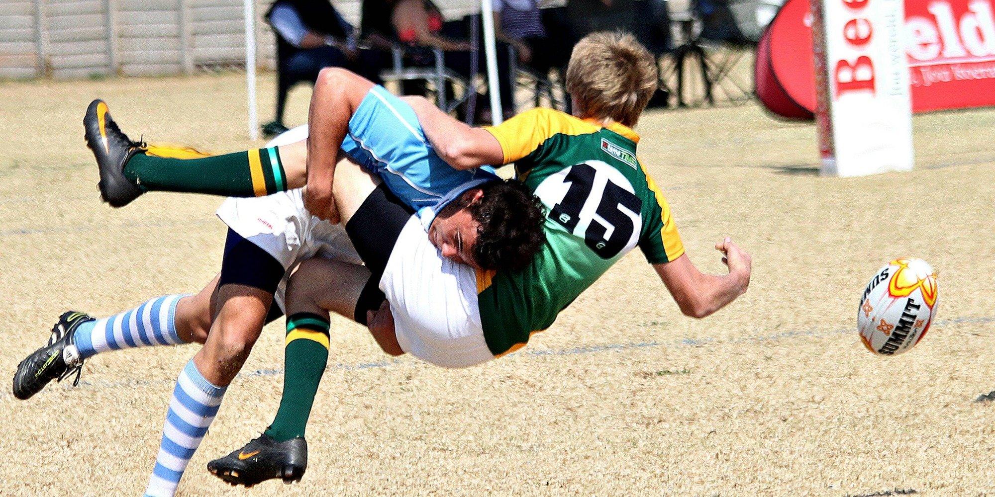 A rugby player is tackled to the floor during a match.