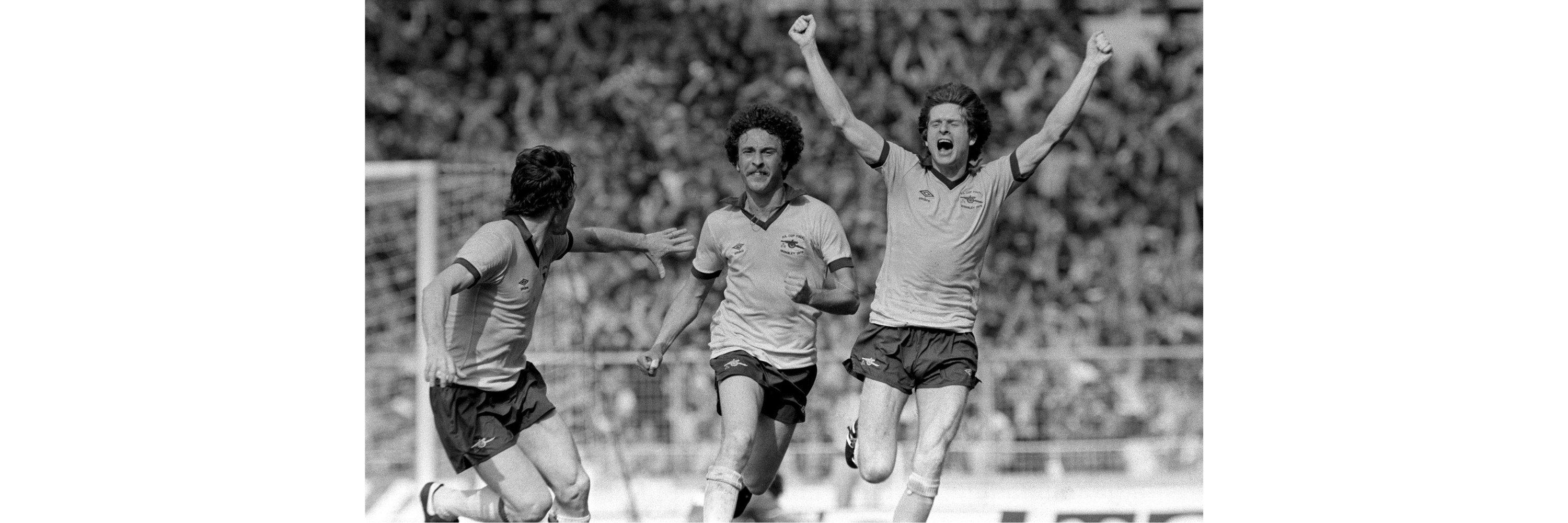 A man on a football pitch celebrating scoring a goal in the FA Cup