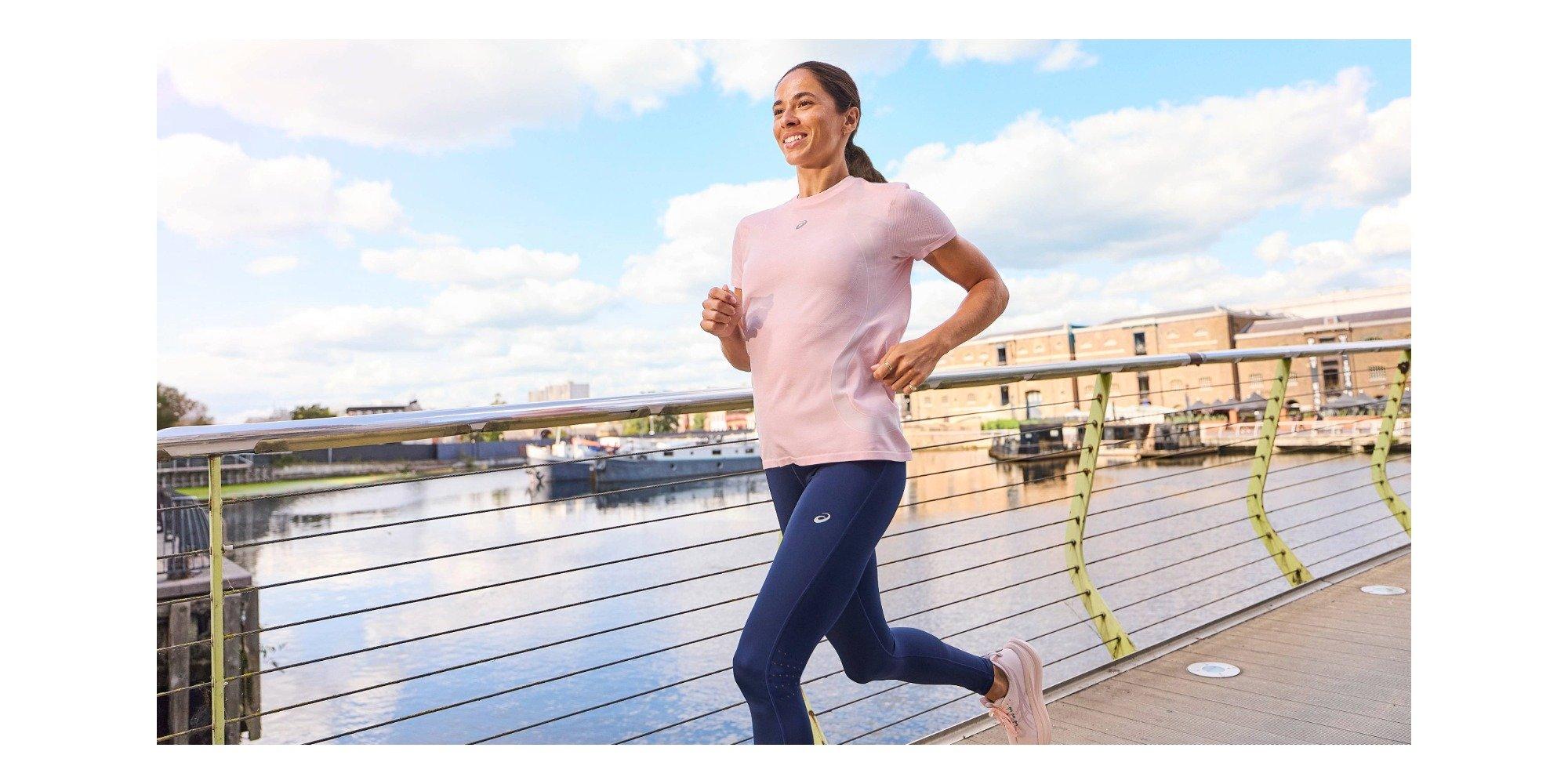 Woman running next to a body of water 