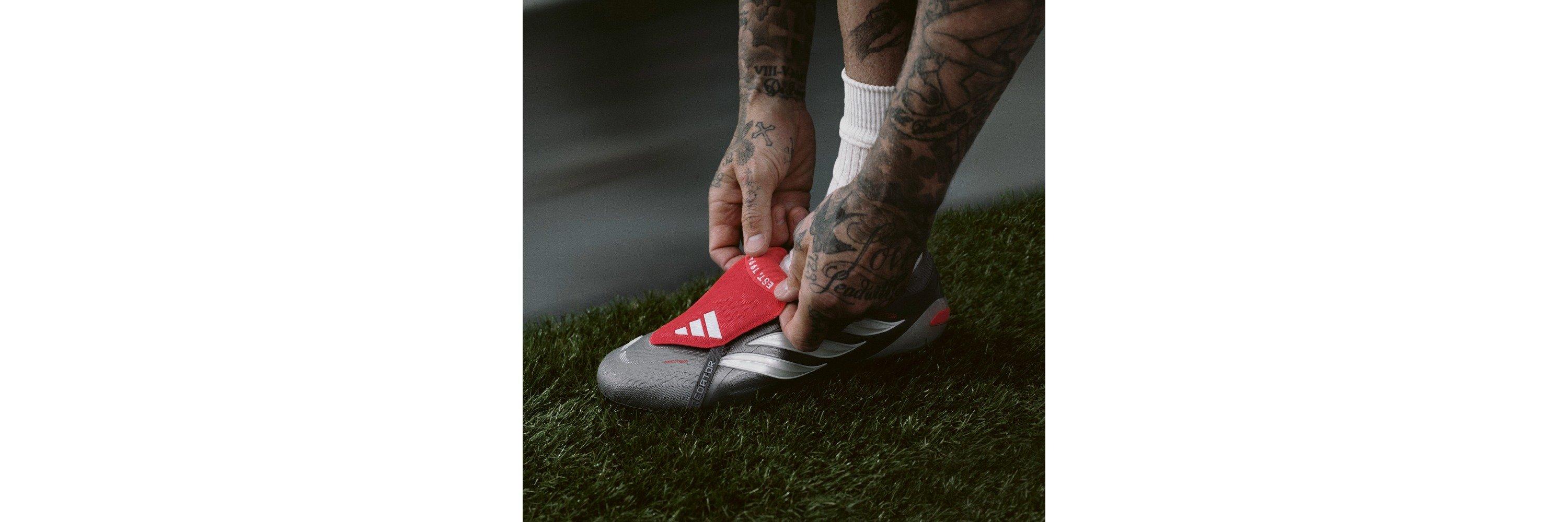 David Beckham adjusting the tongue of his adidas Predator