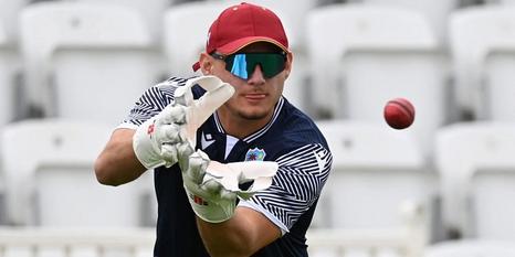 A man catching a cricket ball