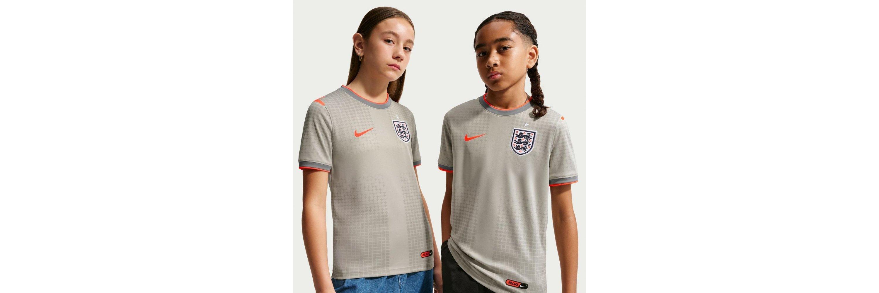 Two kids wearing the Nike X Palace England football shirt