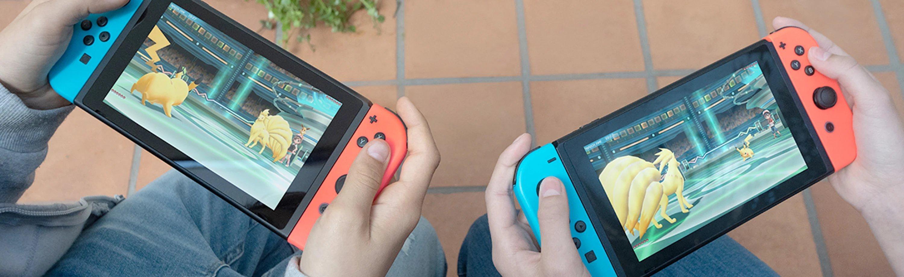 Two children playing Pokemon on the Nintendo Switch
