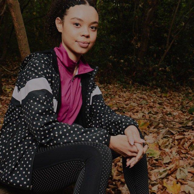Girl posing in the woods in New Balance outfit