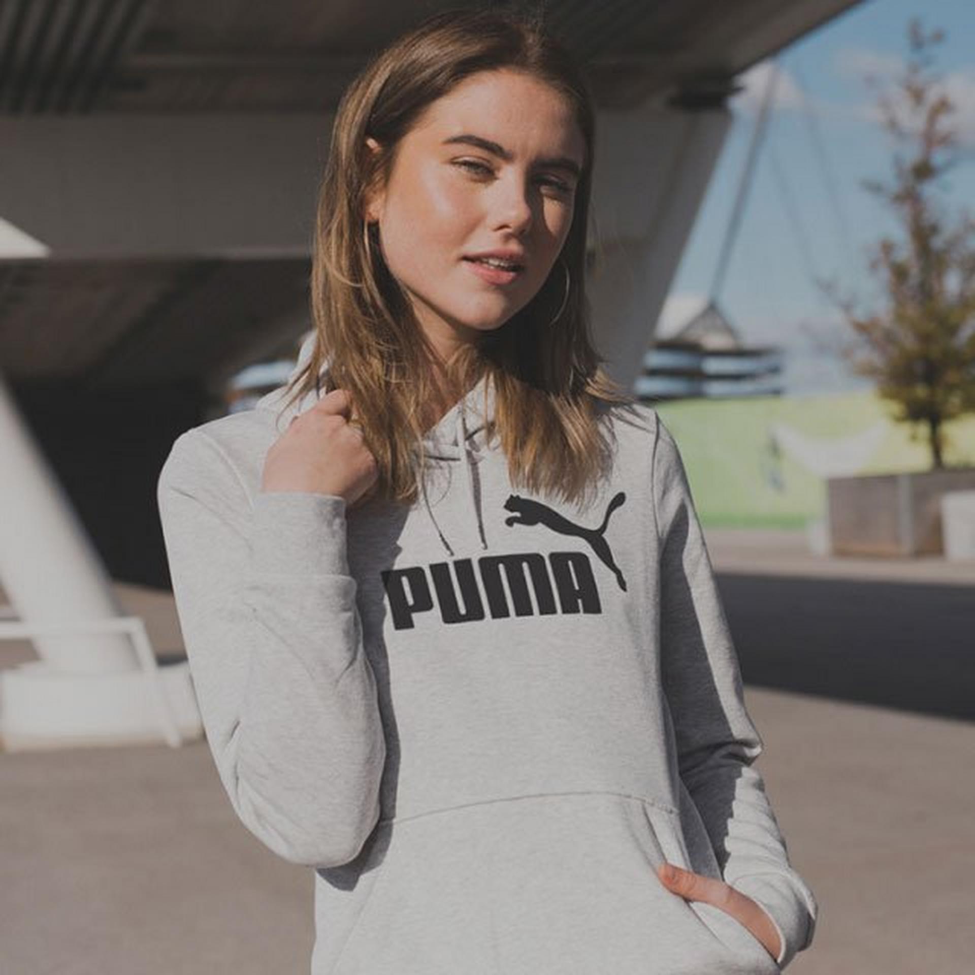 Girl smiling at the camera in a Puma hoodie