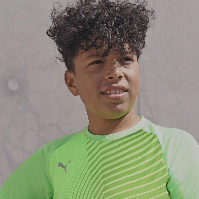 Kid posing in a Puma football trining shirt