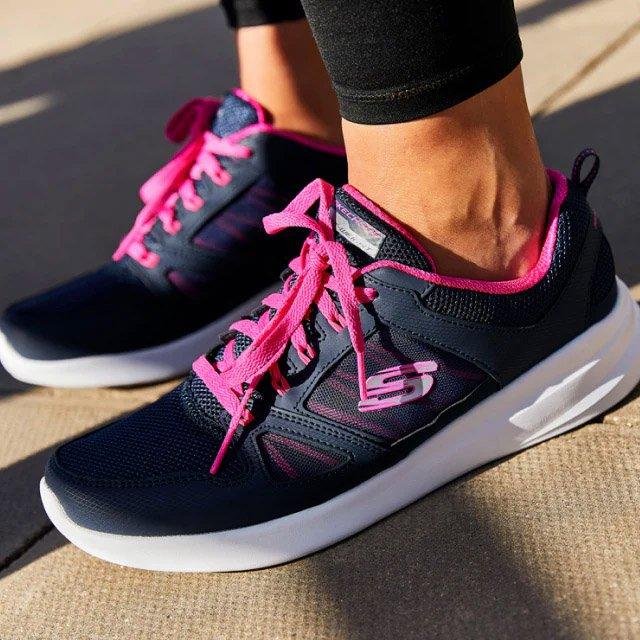 Woman posing in Skechers training gear