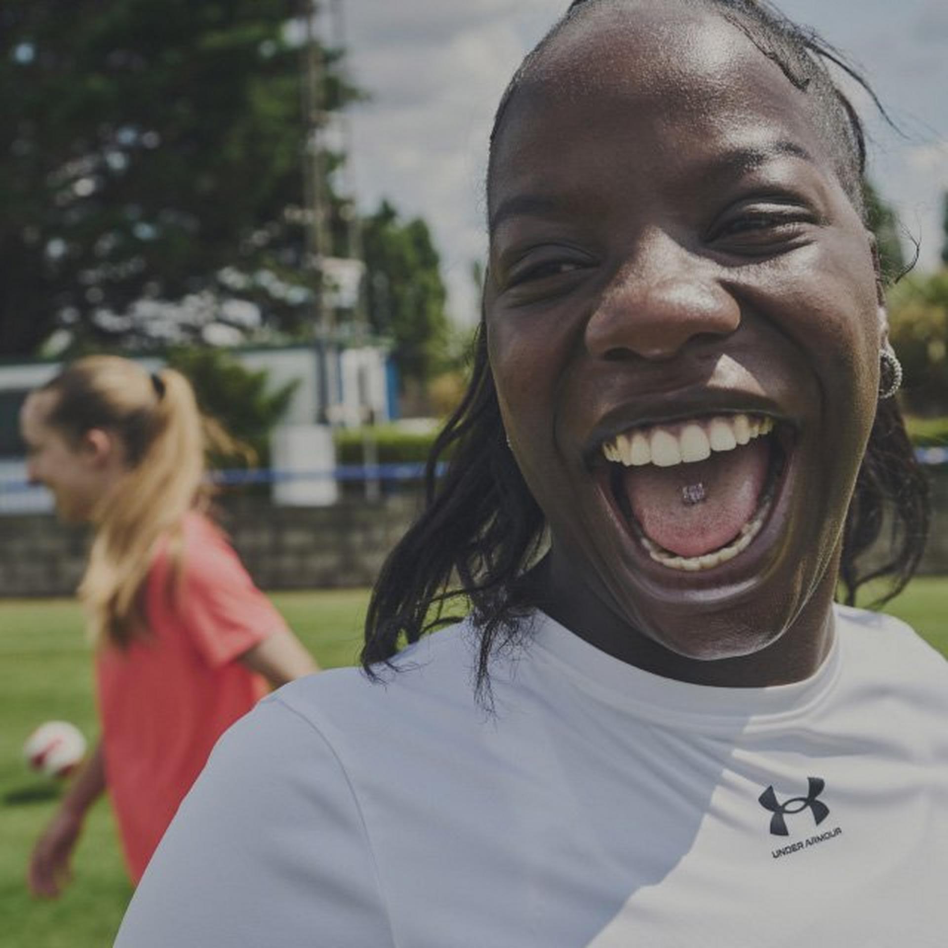 Woman laughing close to the camera in Under Armour Gear