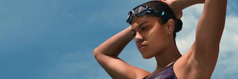 Woman wearing swimming costume and goggles