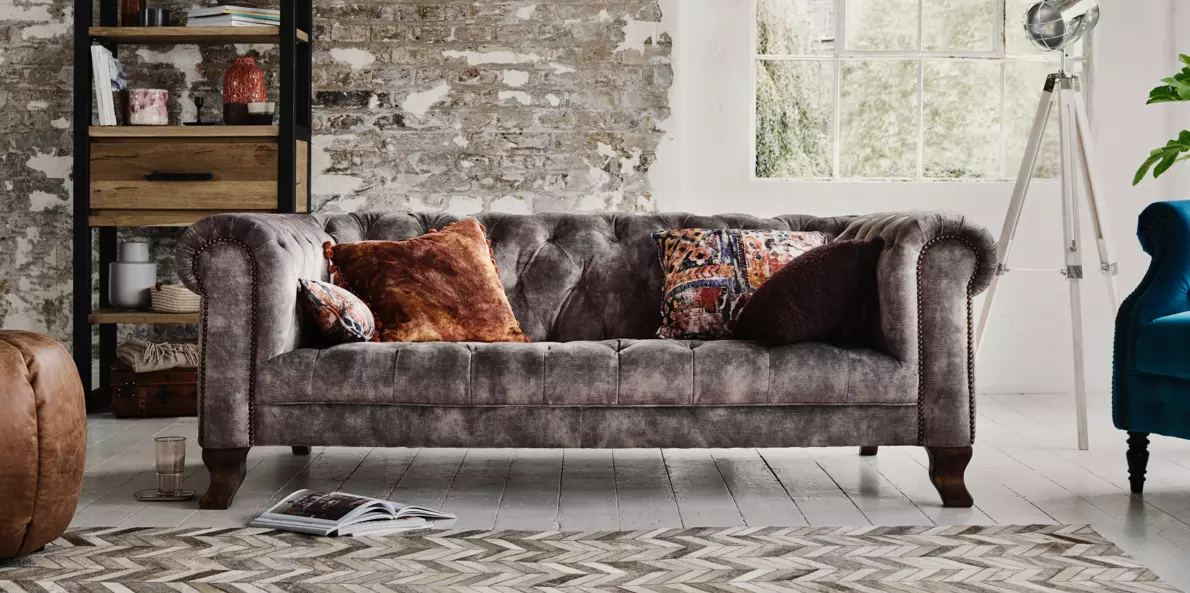 Brown sofa with store grey cushions