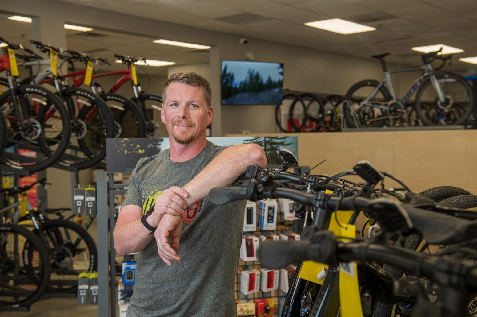 a man in a bike shop looking at a bike
