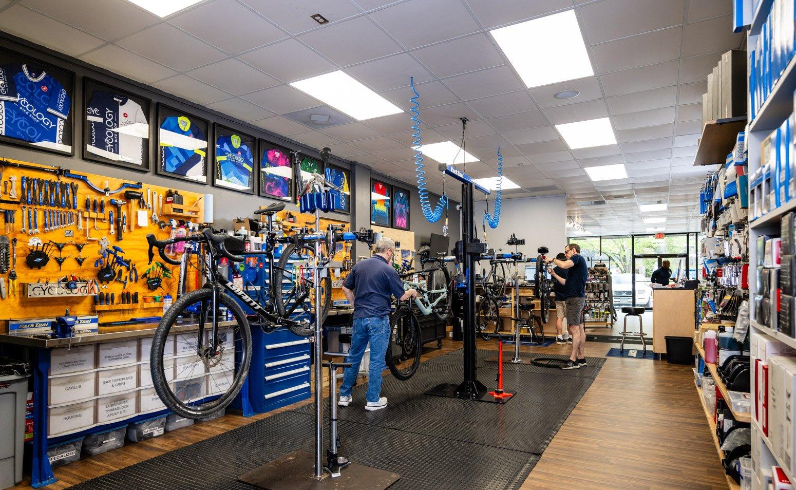 a man in a bike shop looking at a bike