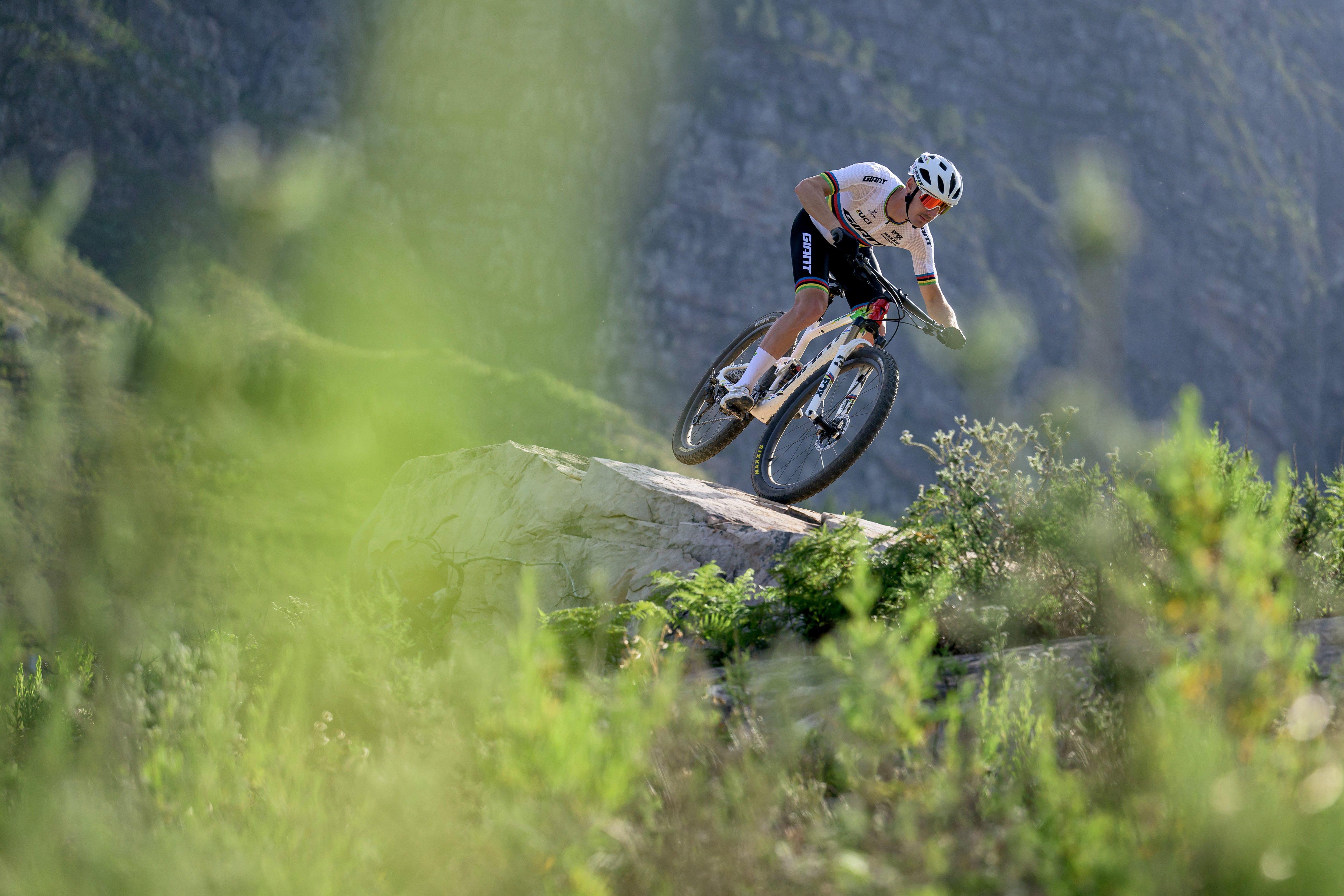 a mountain biker is riding a bike on a rocky hill