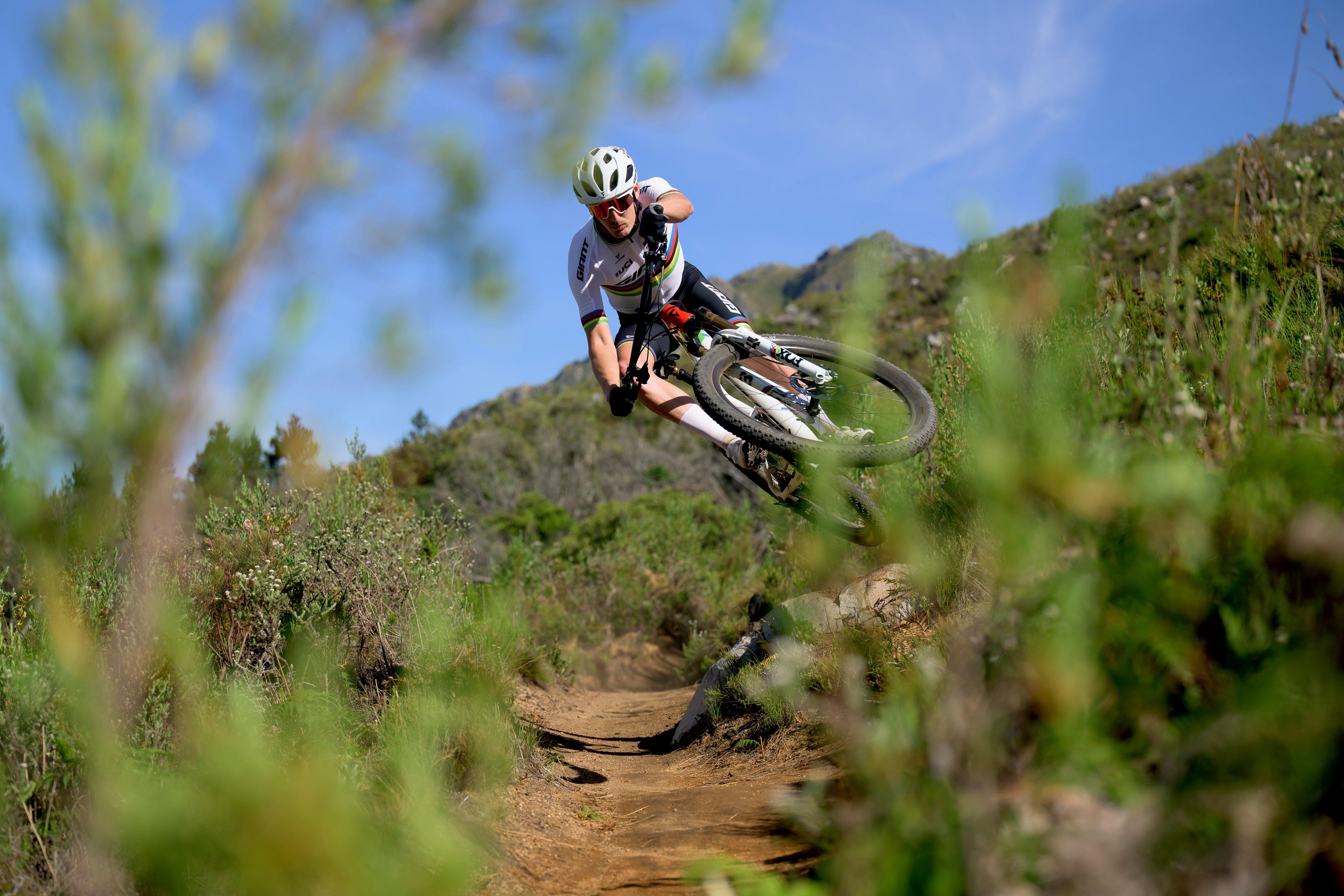 a man riding a mountain bike on a trail in the woods