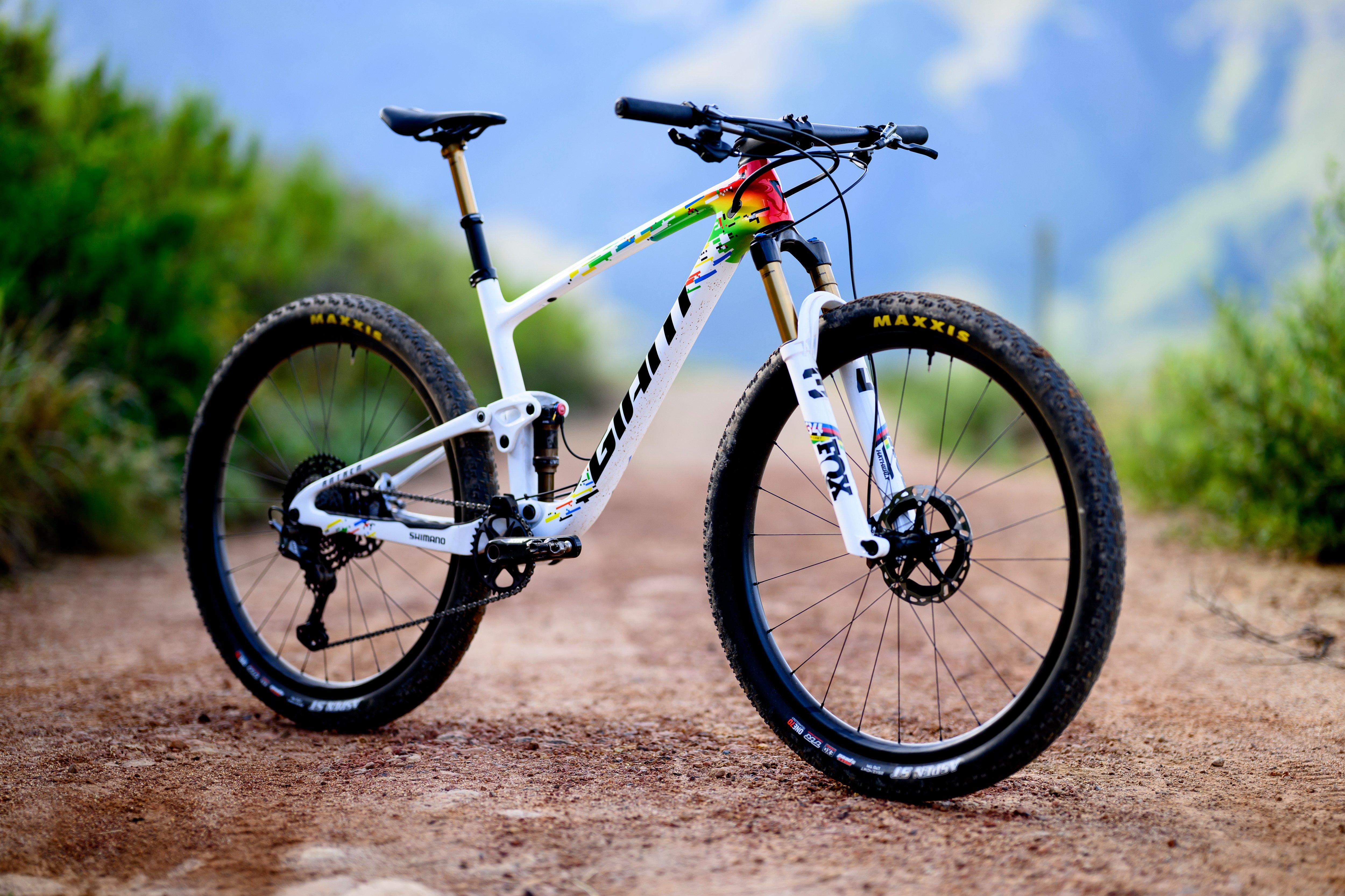 a mountain bike is parked on a dirt road