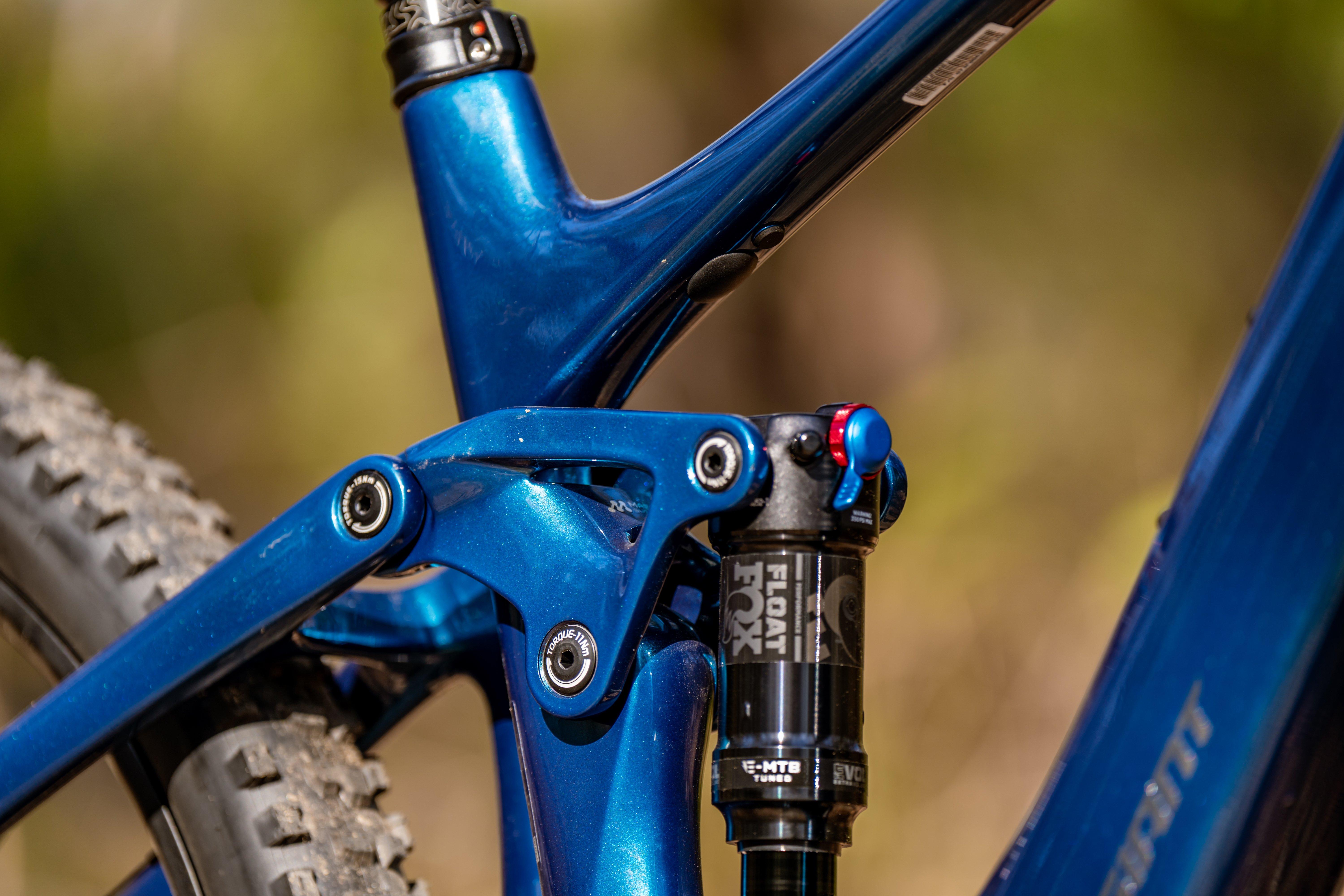 the rear suspension of a blue mountain bike