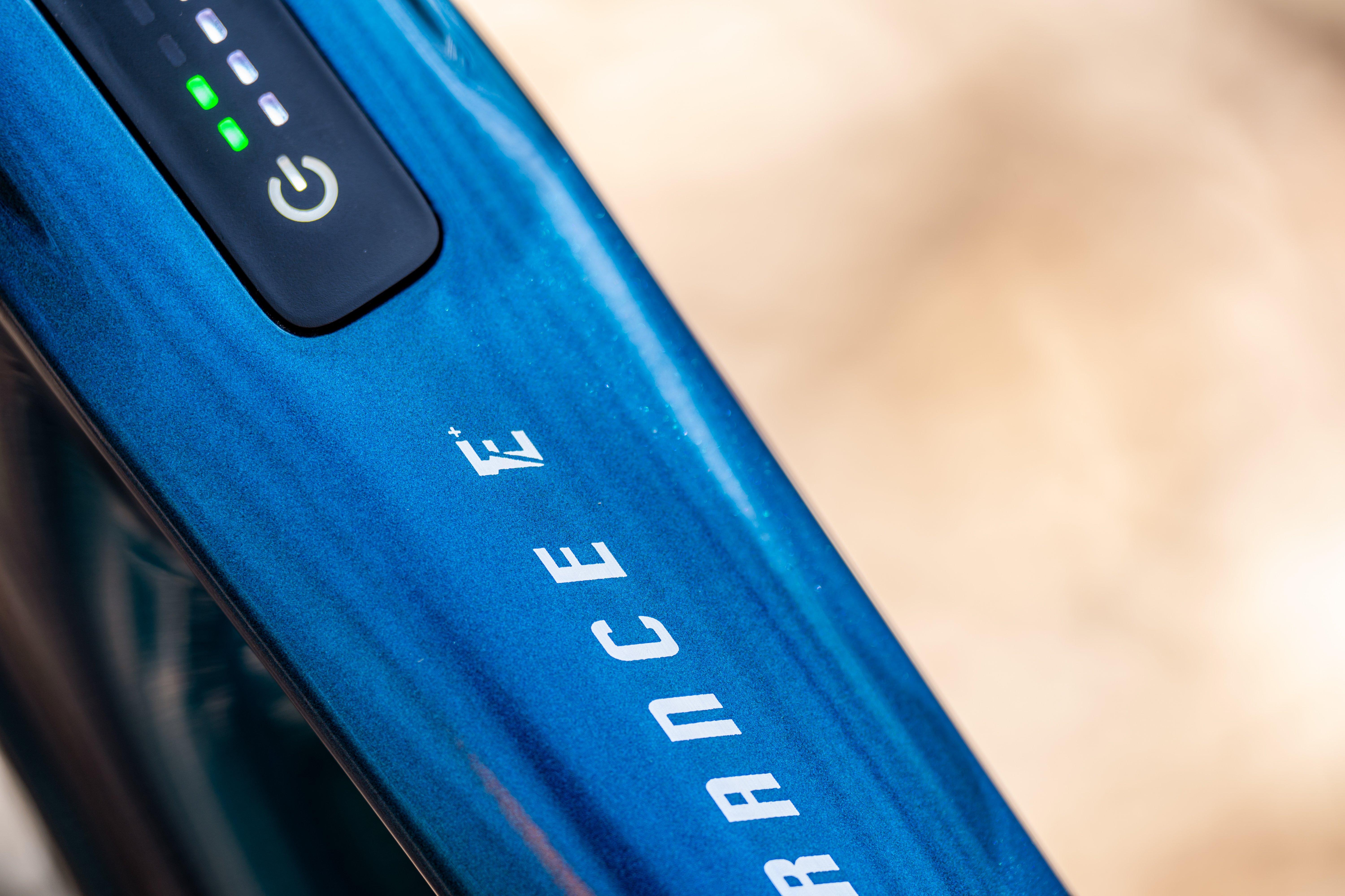a close up of a blue top tube with a logo on it