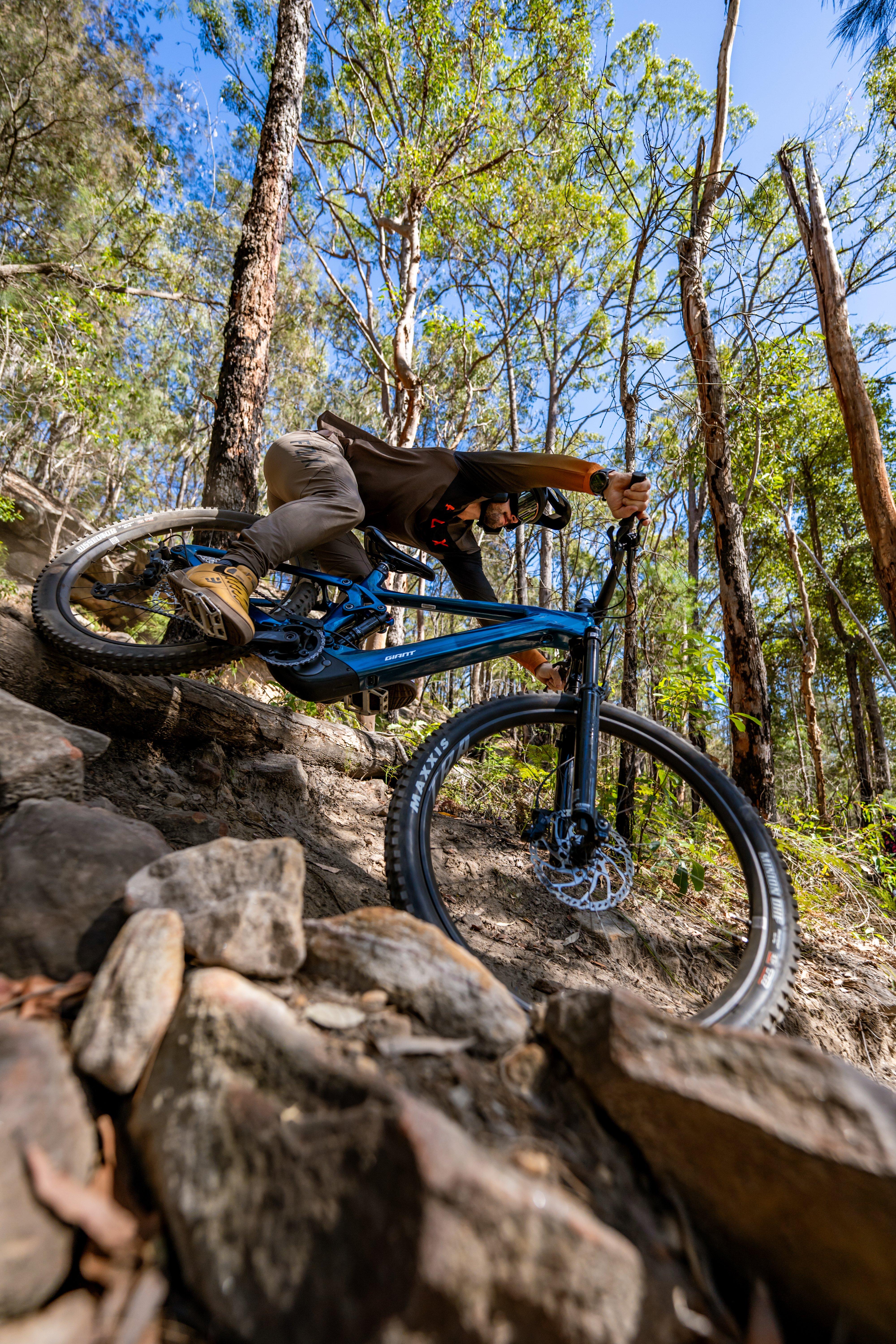 a mountain biker is riding down a rocky trail