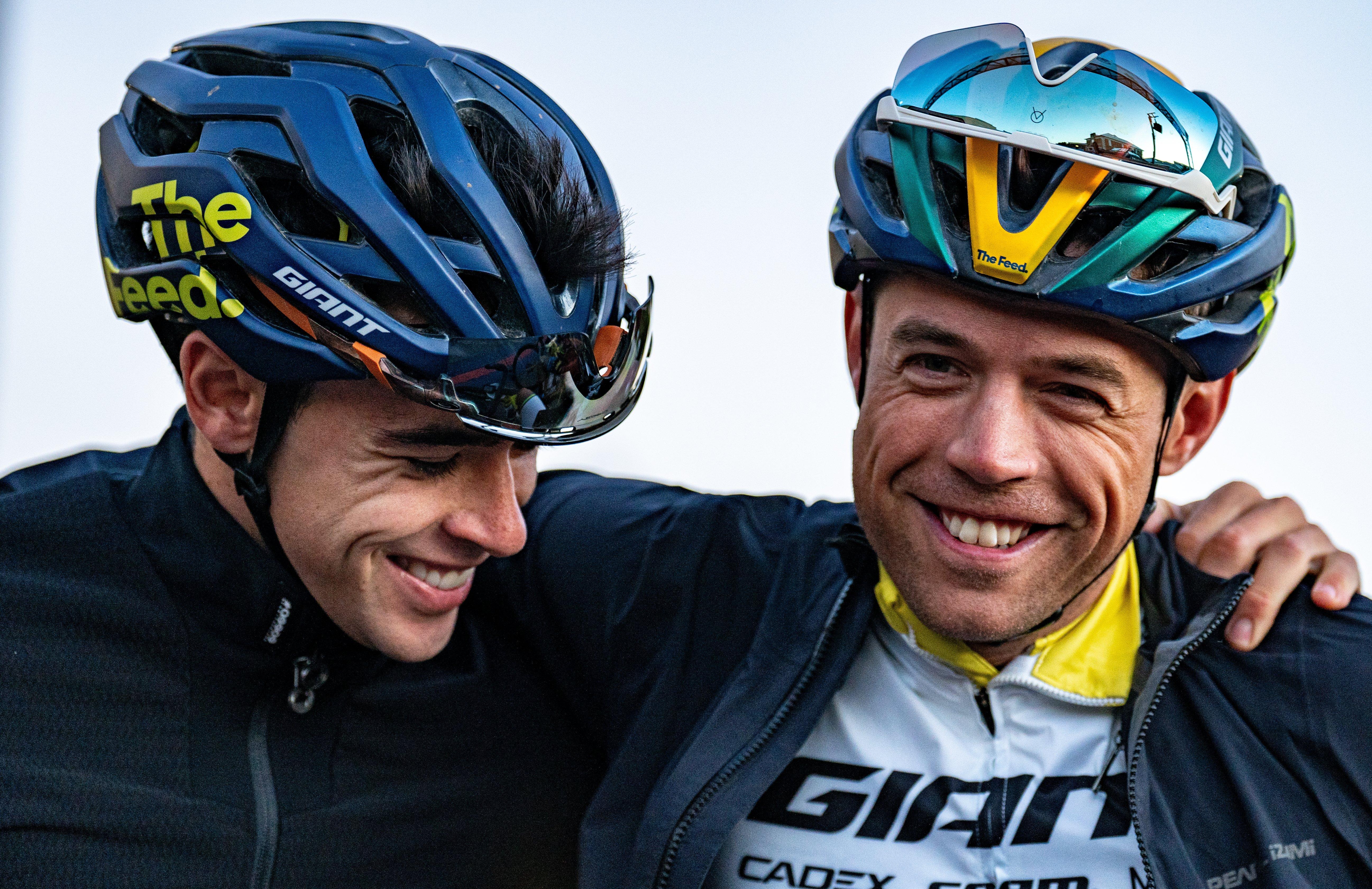 two men are wearing helmets and smiling for the camera