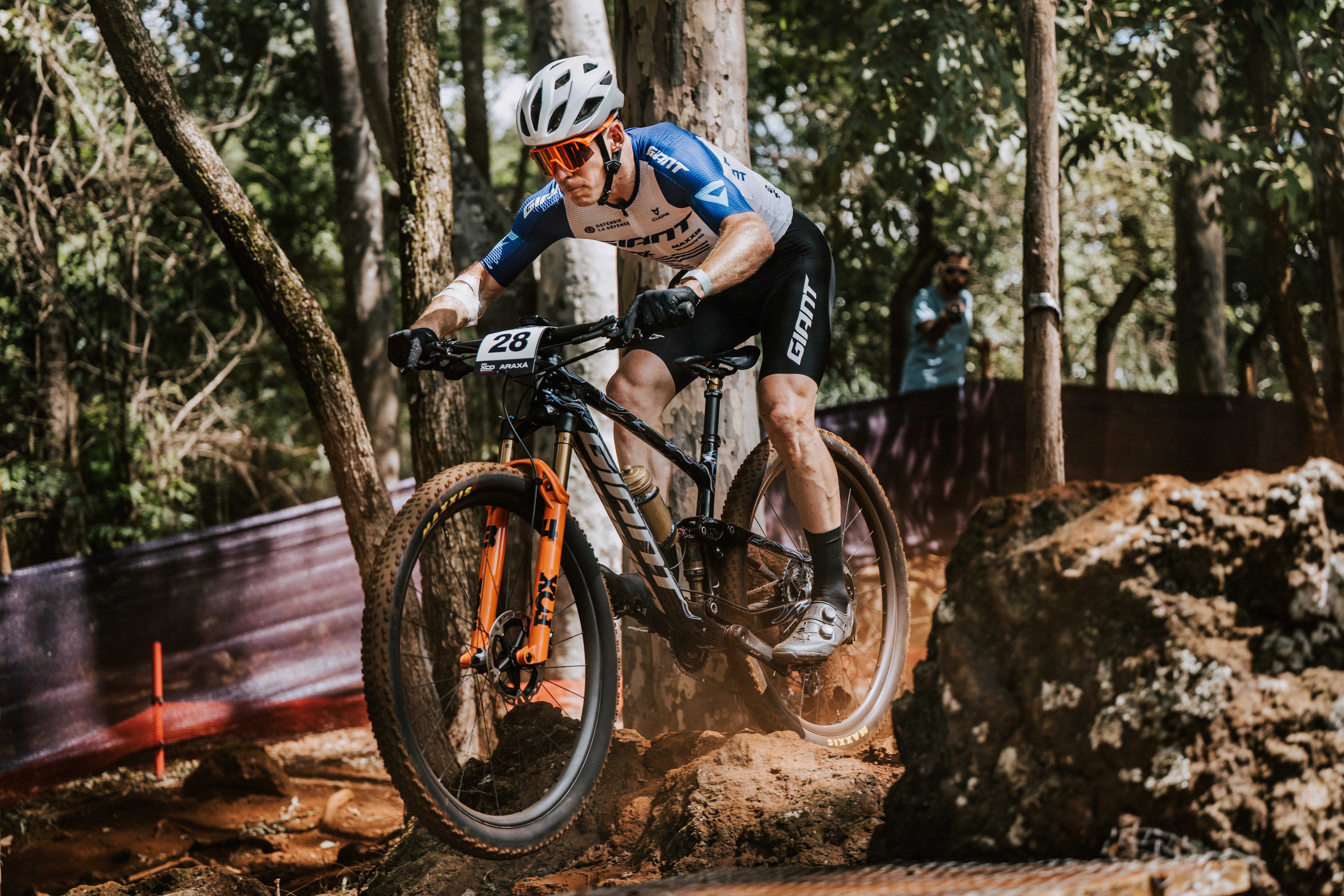 a man riding a mountain bike on a trail in the woods