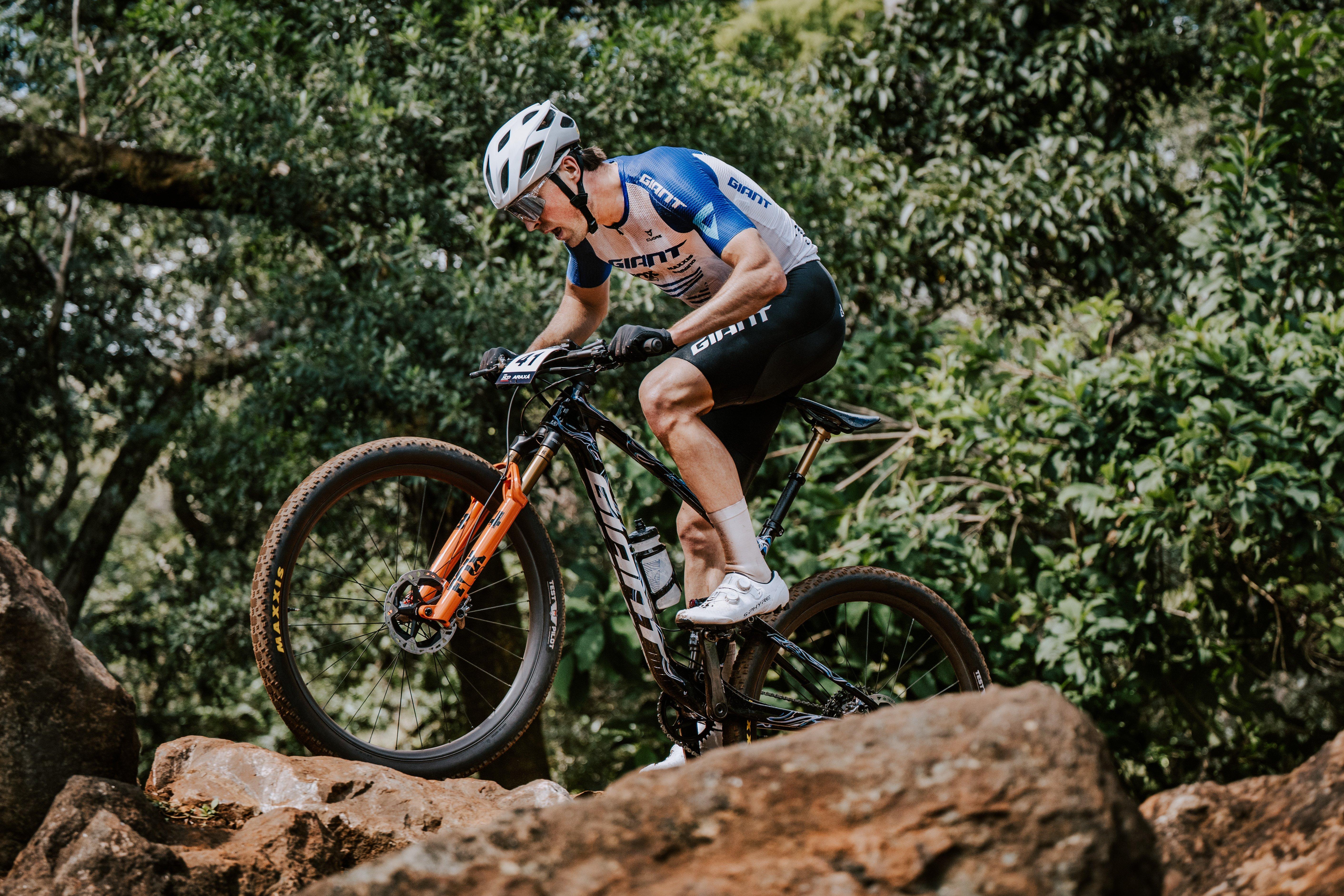a man riding a mountain bike on a rocky trail