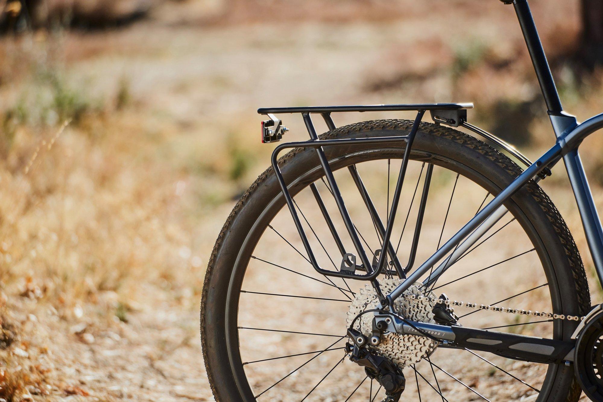 a close up of a bicycle on a dirt road