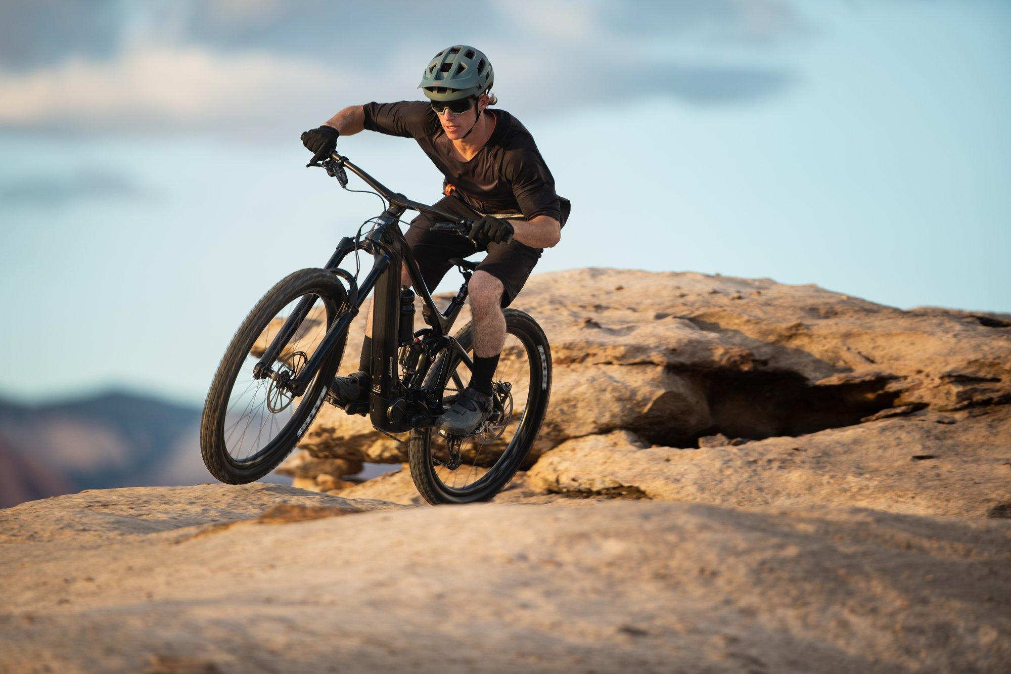 a man riding a mountain bike on a trail in the desert