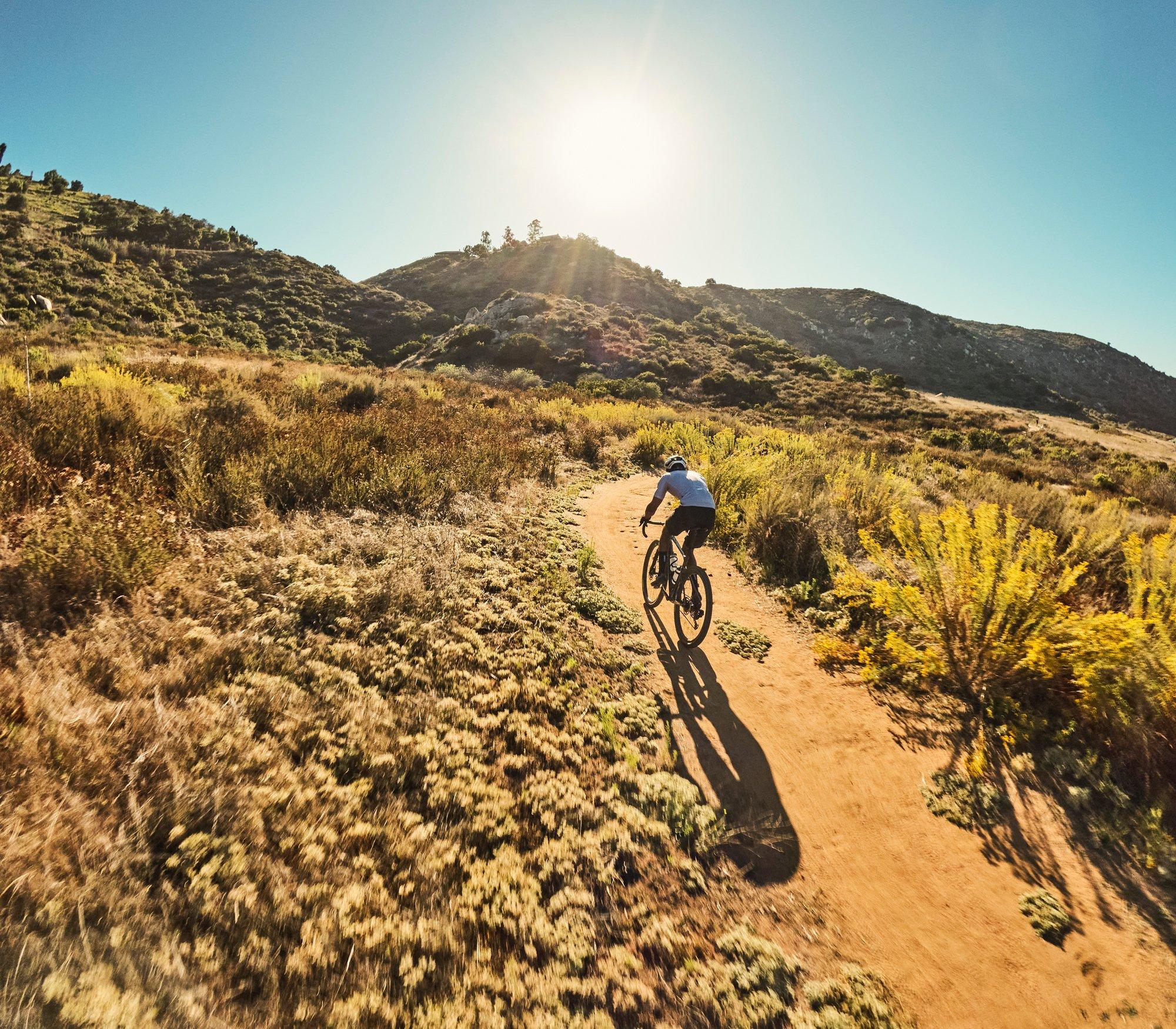 gravel cyclist riding dirt road