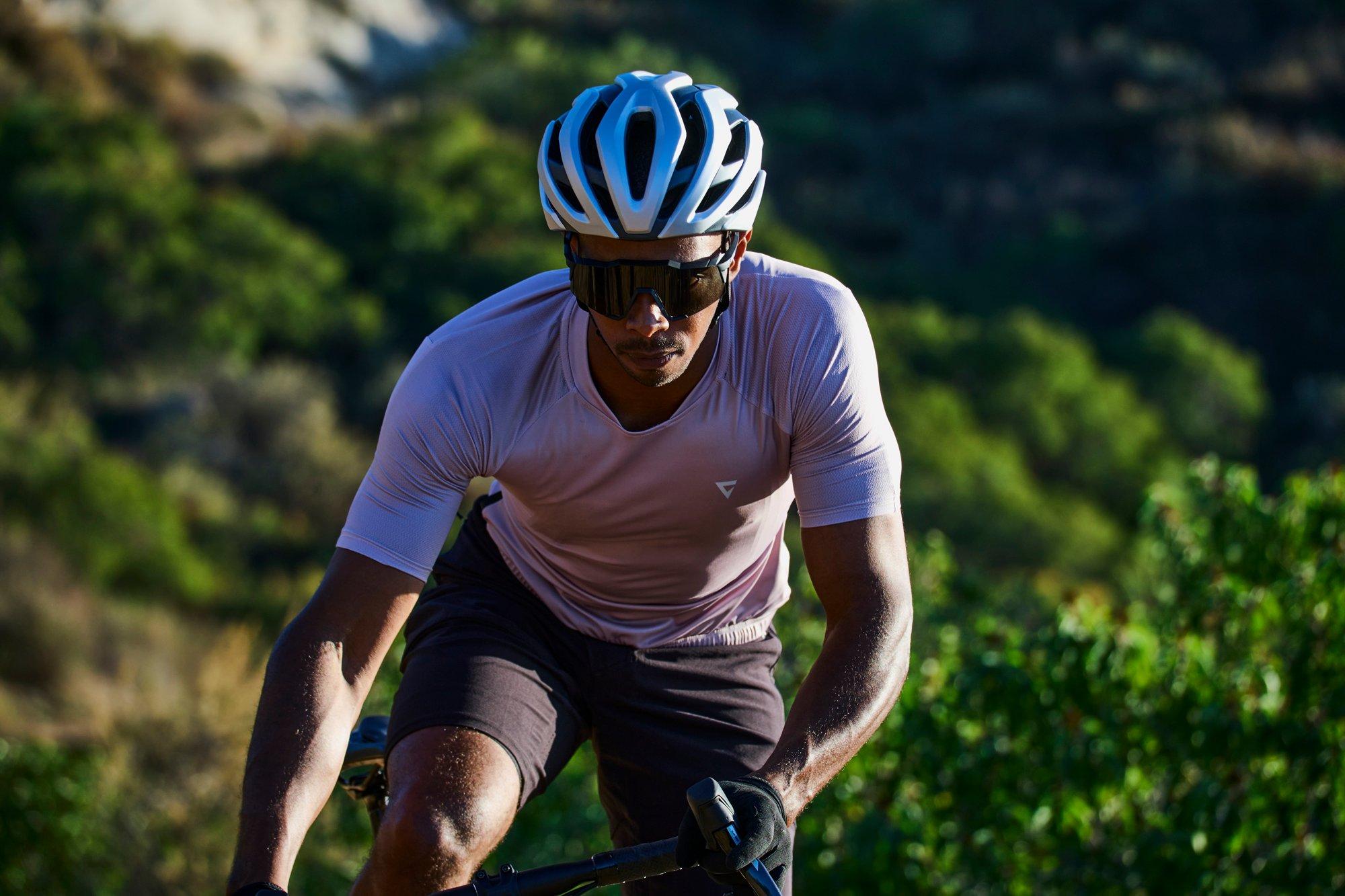 a man riding a bike on a trail with a helmet on