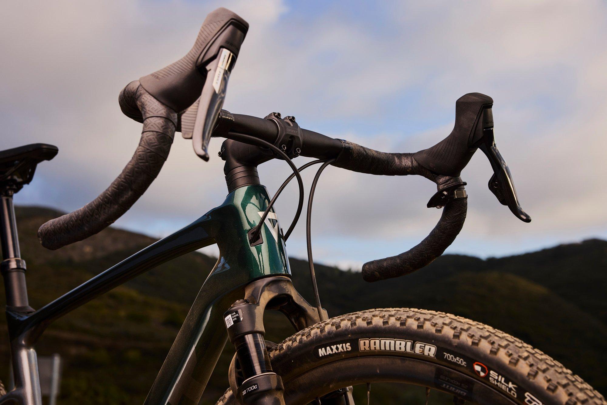 a close up of a bicycle with handlebars and brake levers