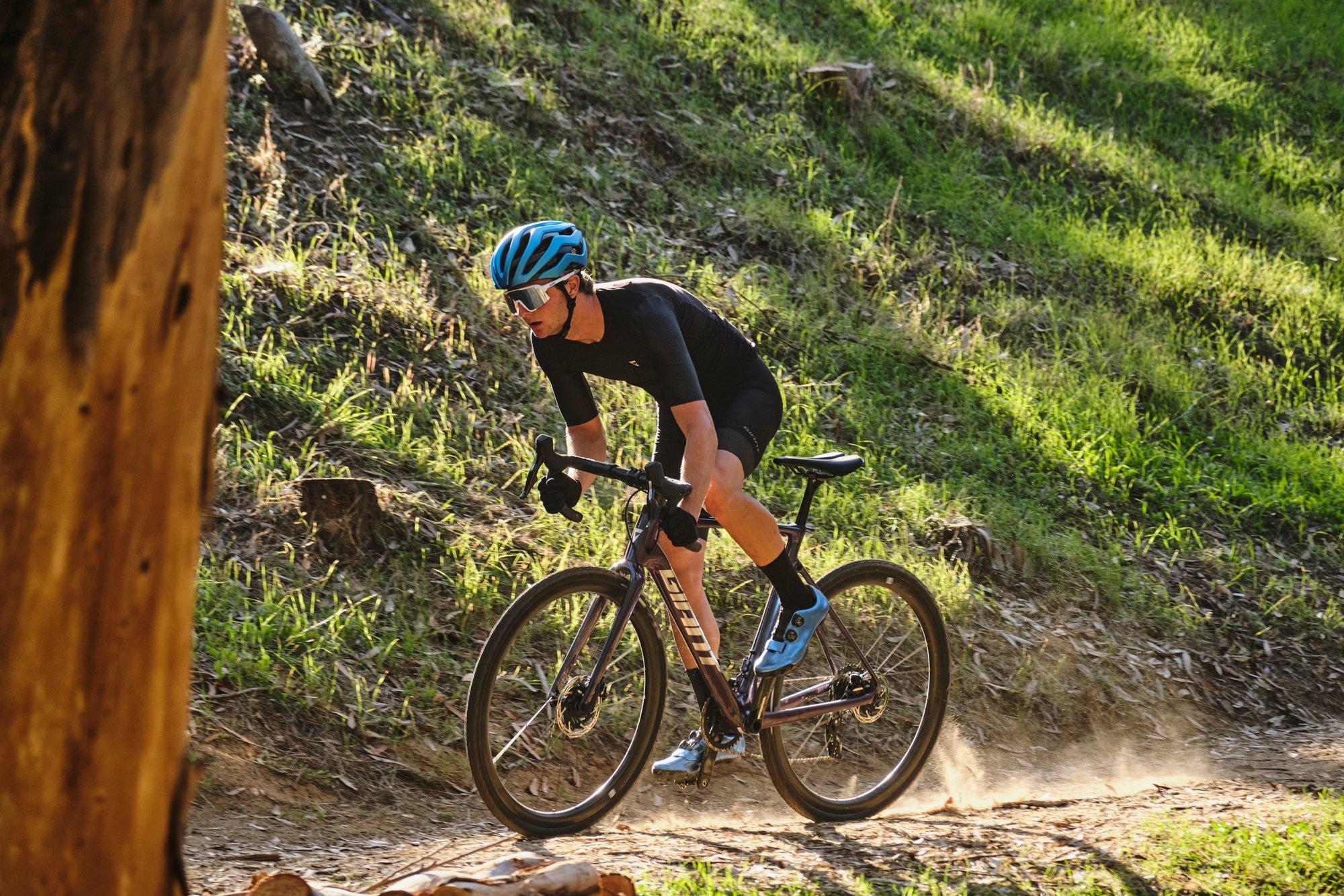 a man riding a bike on a trail in the woods