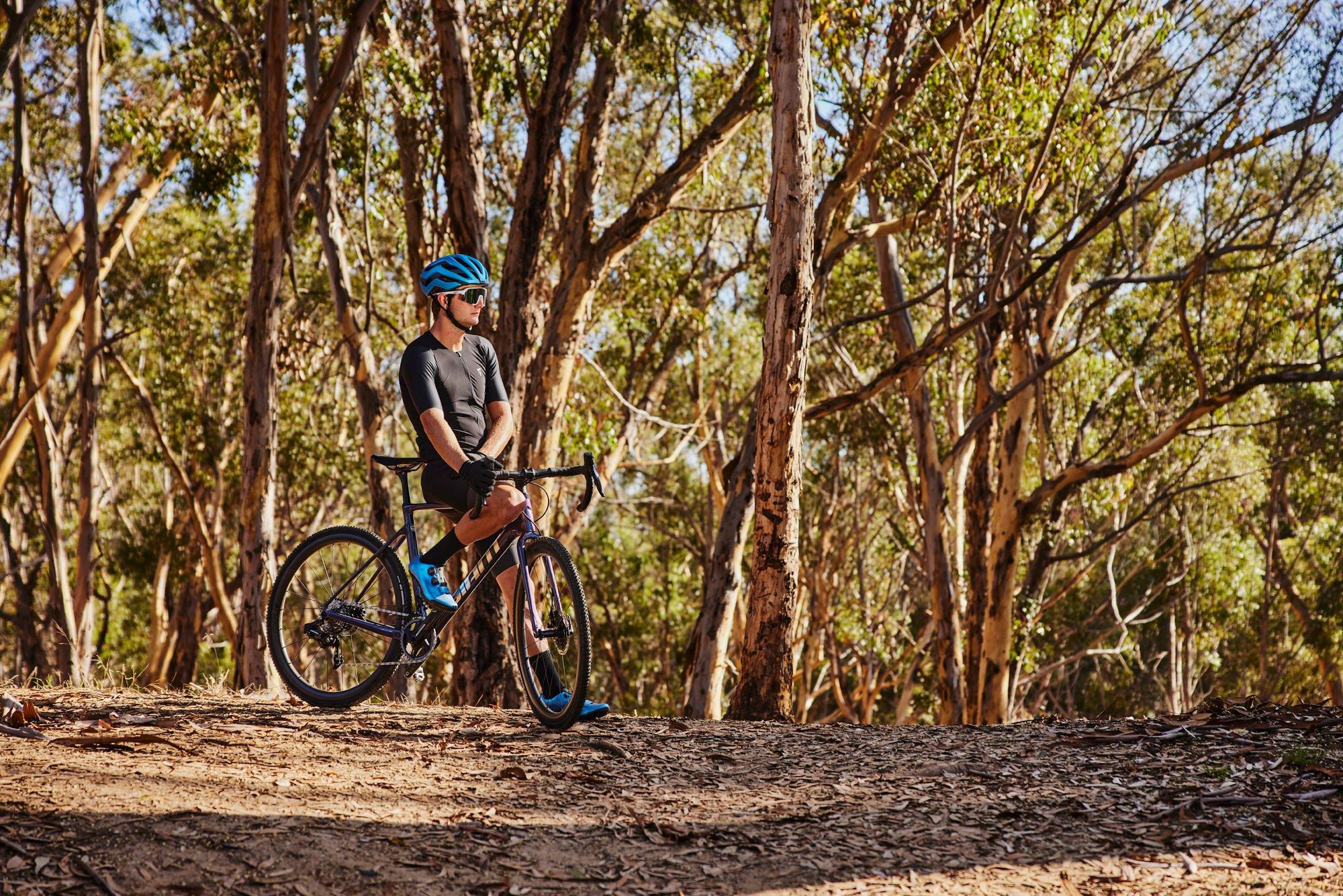 a man riding a bike in the woods