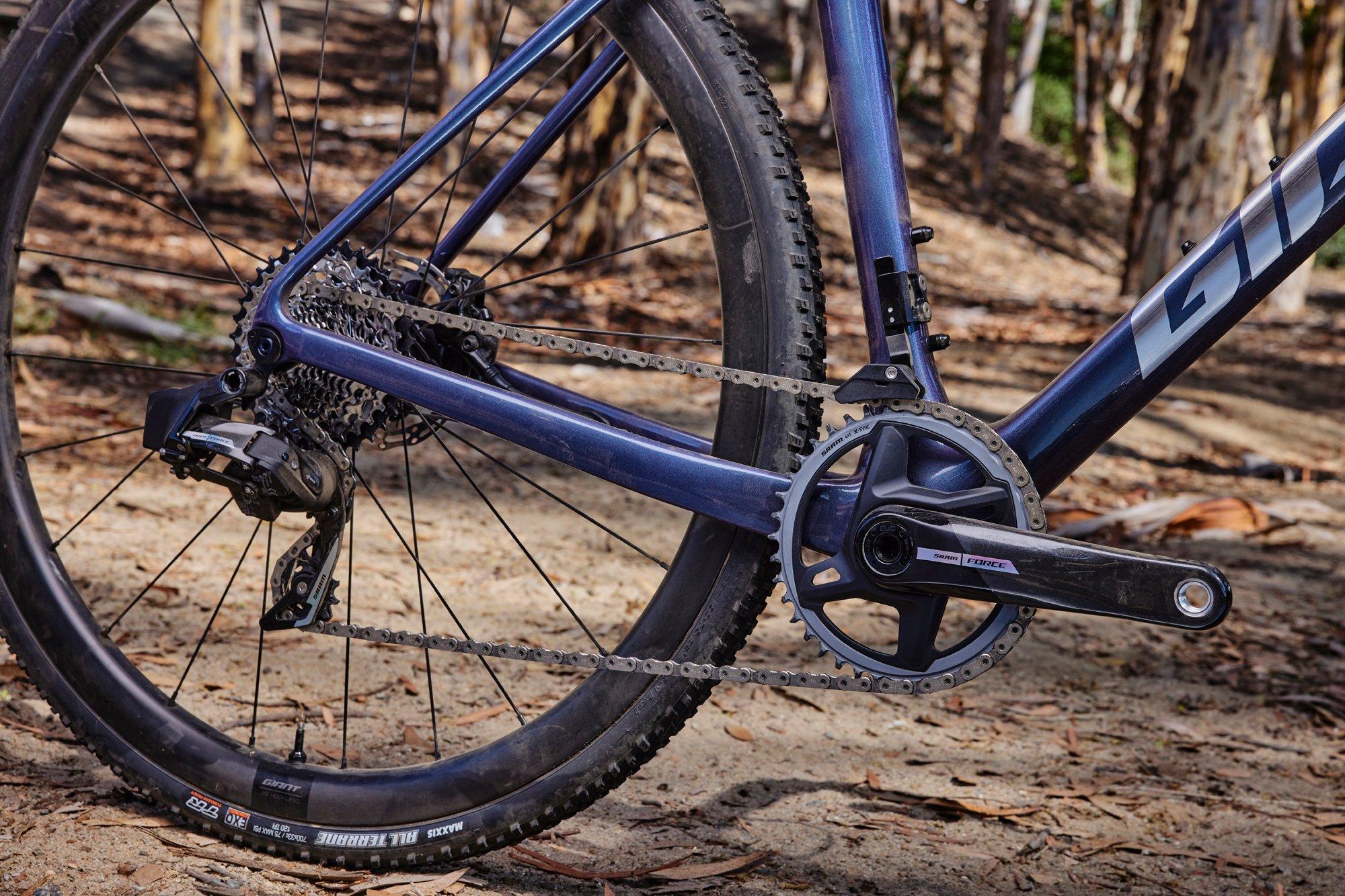 a close up of a blue bike on a dirt road