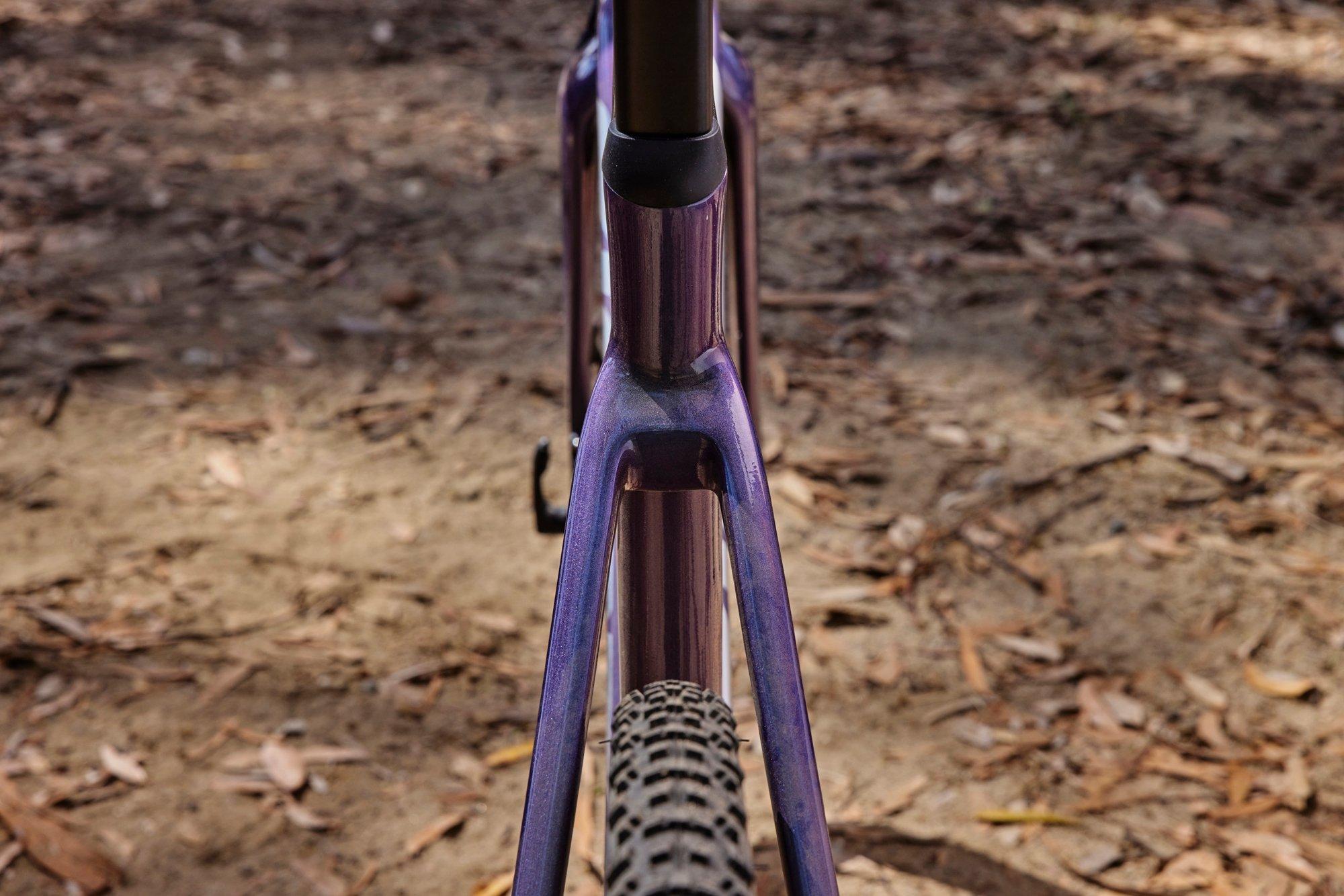 a close up of a purple bike with a purple handle bar