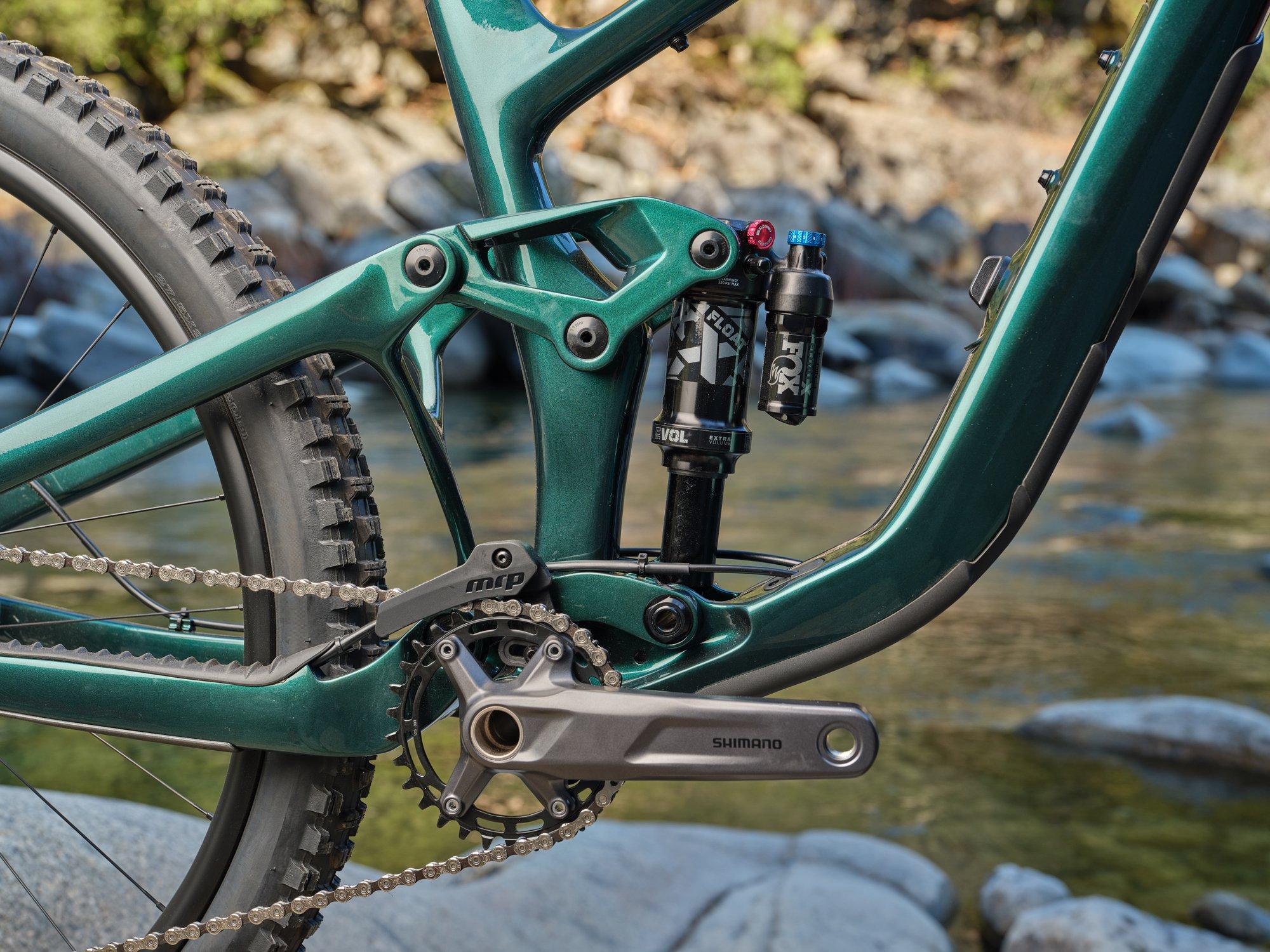 a close up of a green mountain bike sitting on rocks