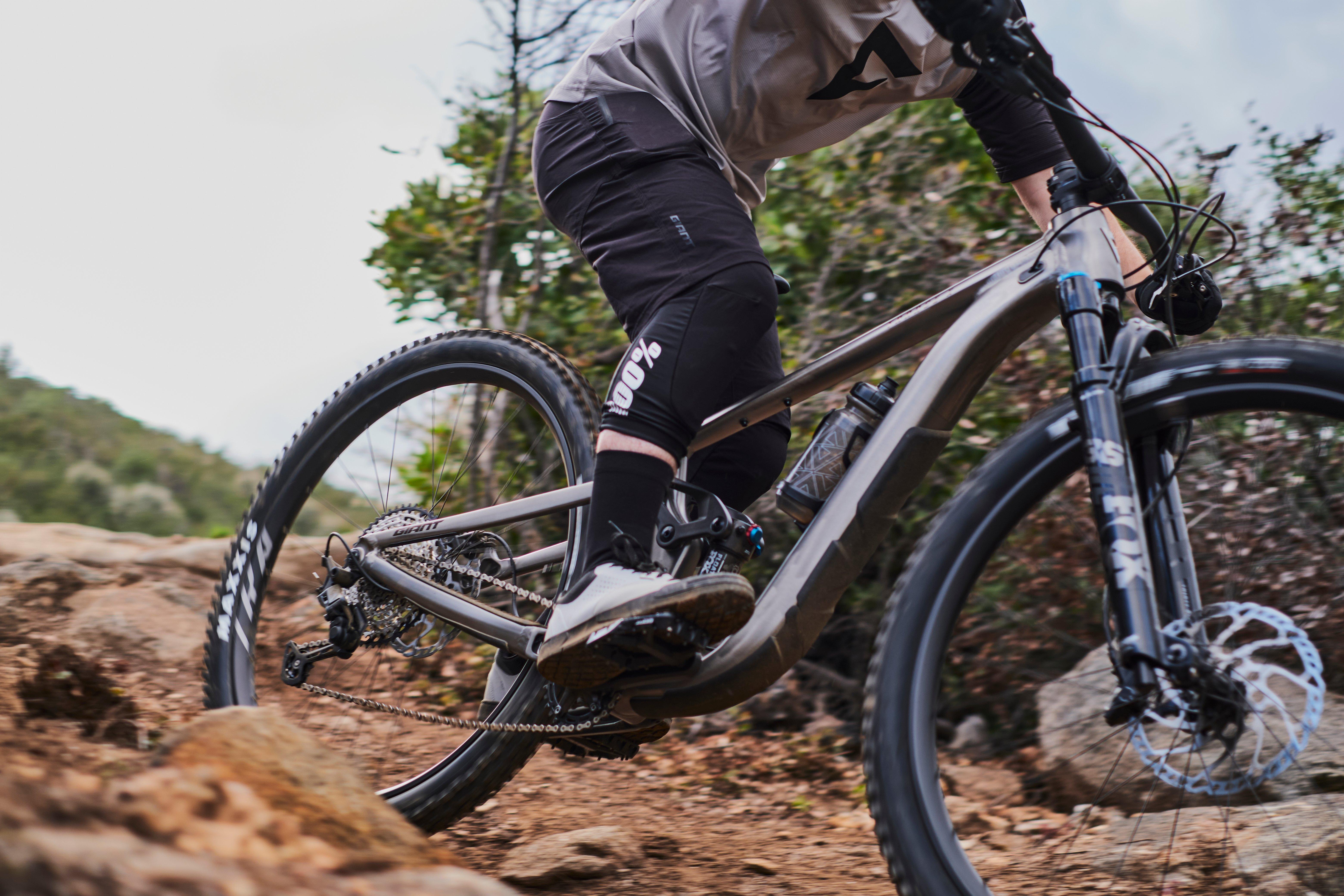 a man riding a mountain bike on a rocky trail