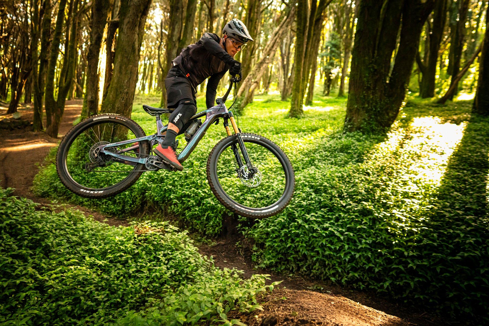 a man riding a mountain bike in the woods