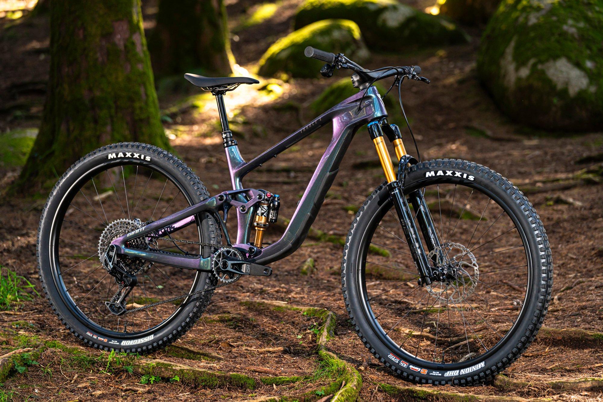 a mountain bike is parked in the middle of a forest