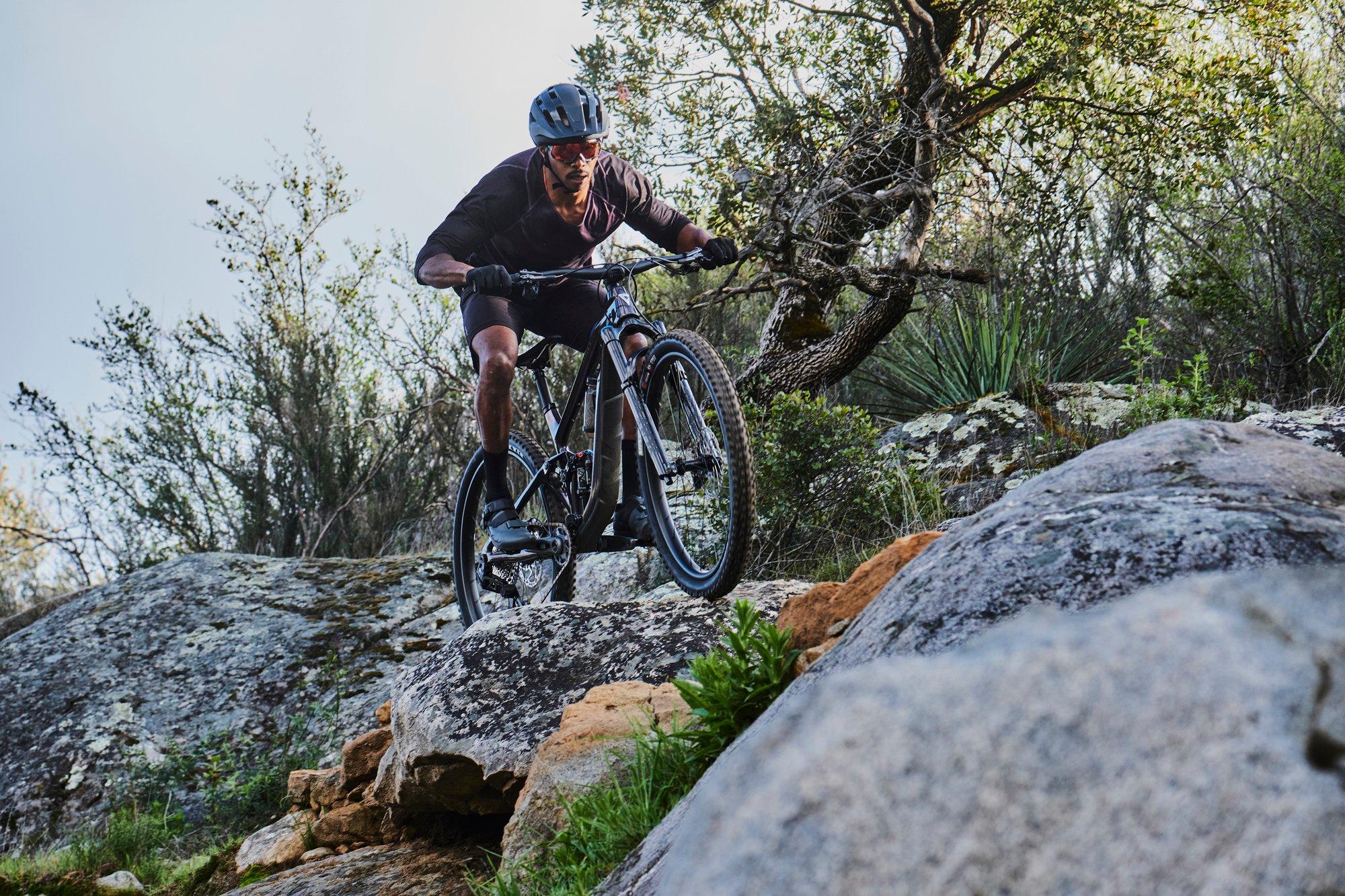 a man riding a mountain bike on a rocky trail