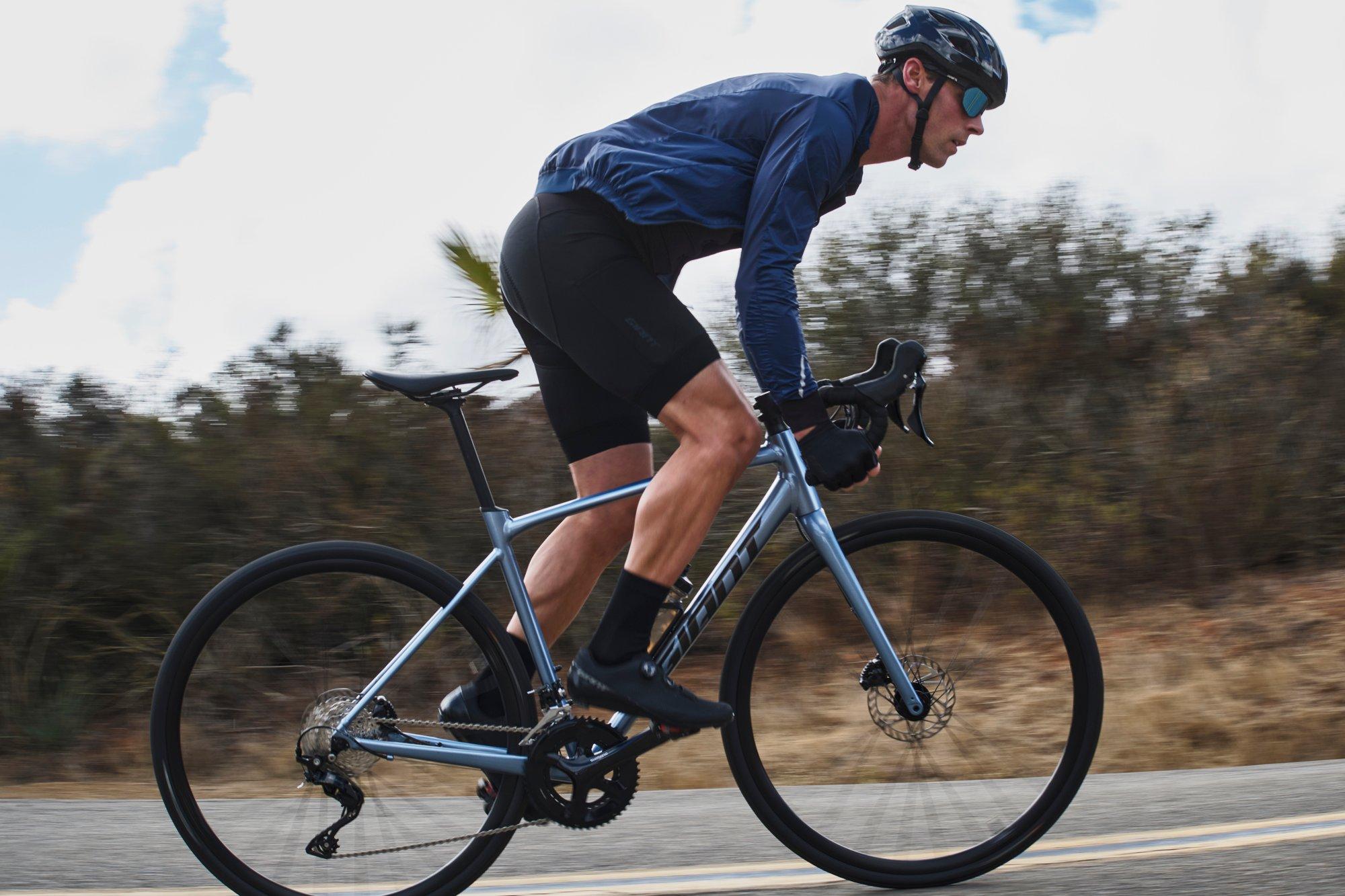 a man sprinting on a road bike
