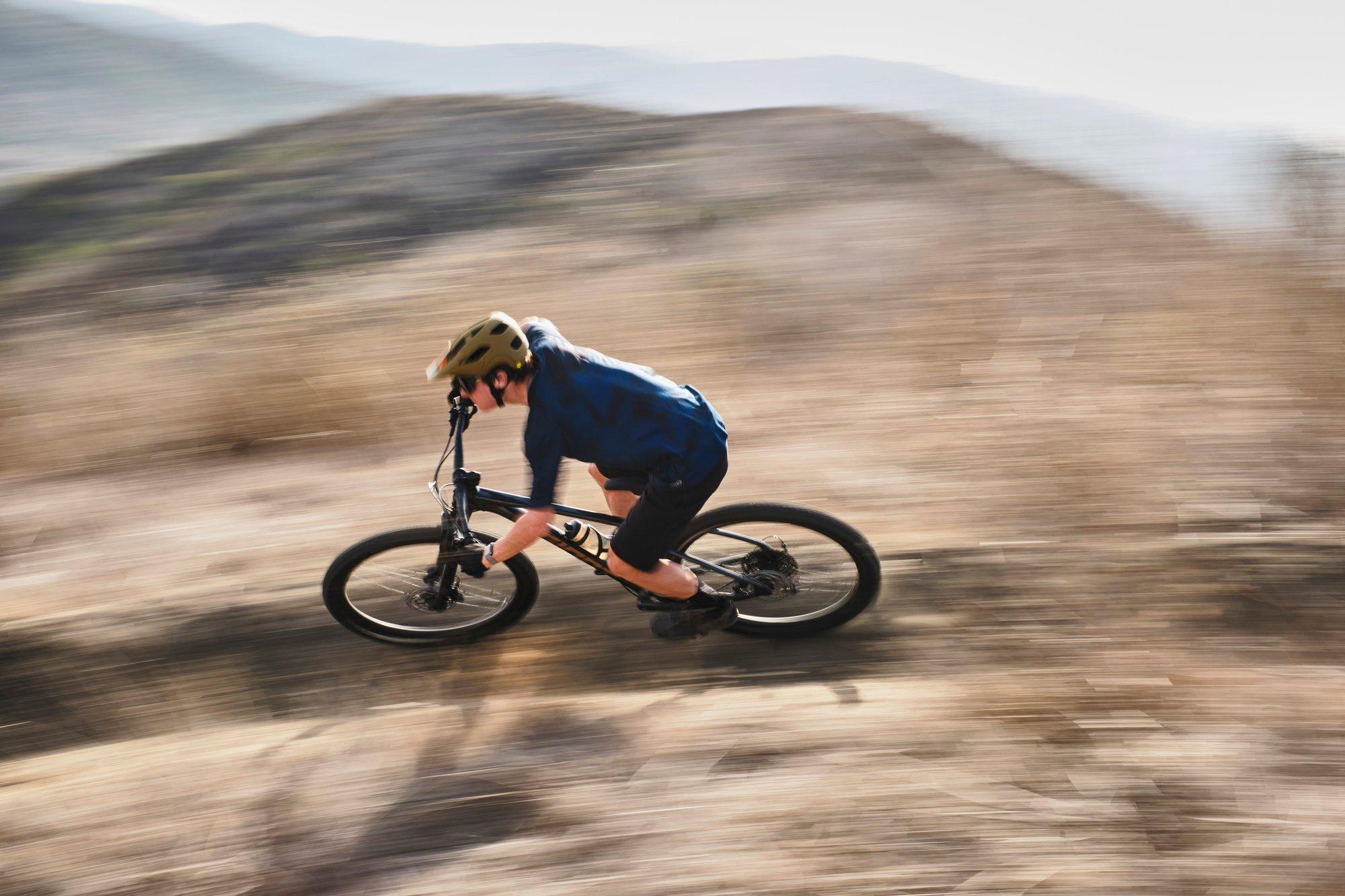 a man riding a mountain bike on a dirt hill