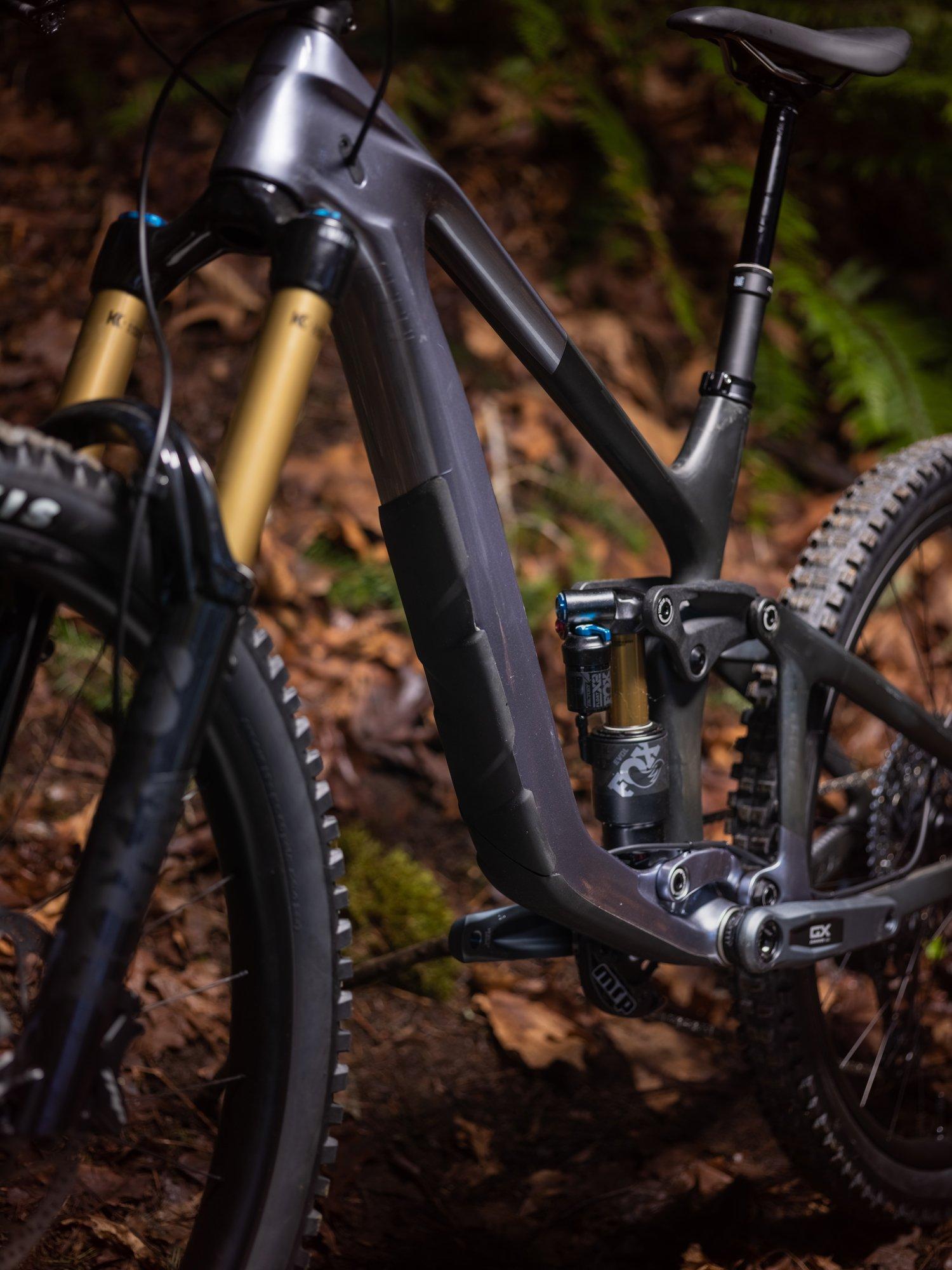 a mountain bike is parked in the woods near a tree